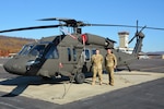 Chief Warrant Officer 4 Frank Madeira, left, and Chief Warrant Officer 4 Justin Meyer, both instructor pilots at the Eastern Army National Guard Aviation Training Site, pose in front of a UH-60V Black Hawk helicopter on Muir Army Airfield at Fort Indiantown Gap, Pa., Nov. 10, 2021.