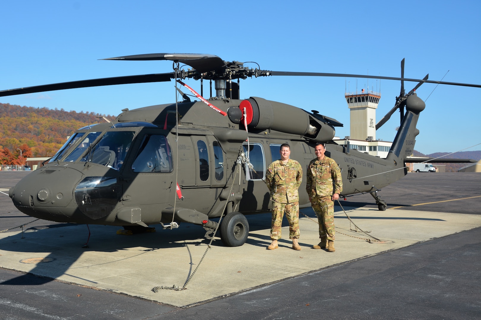 Chief Warrant Officer 4 Frank Madeira, left, and Chief Warrant Officer 4 Justin Meyer, both instructor pilots at the Eastern Army National Guard Aviation Training Site, pose in front of a UH-60V Black Hawk helicopter on Muir Army Airfield at Fort Indiantown Gap, Pa., Nov. 10, 2021.