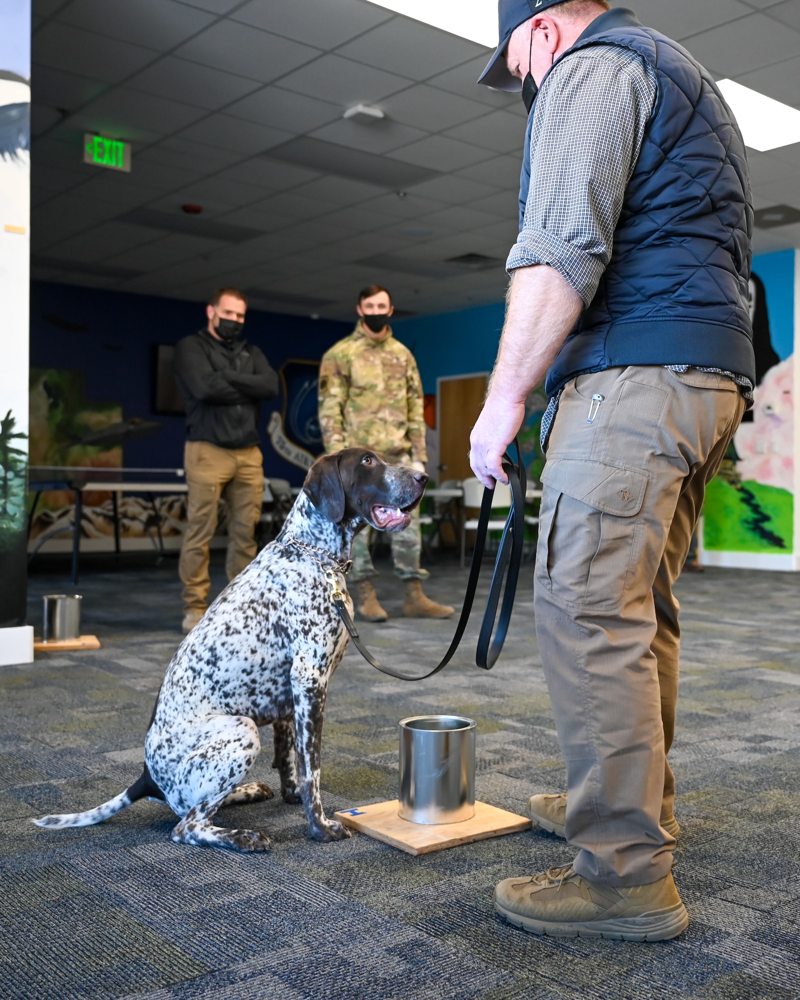 Thad Hansen, K-9 handler from Salt Lake Police Department, praises K-9 Pongo as he signals finding a scent related to an explosive Nov. 17, 2021, at Hill Air Force Base, Utah. Military working dogs and their handlers from 75th Security Forces Squadron conducted joint K-9 training with local, state and federal law enforcement dog teams to foster partner relations and enhance capabilities. (U.S. Air Force photo by Cynthia Griggs)