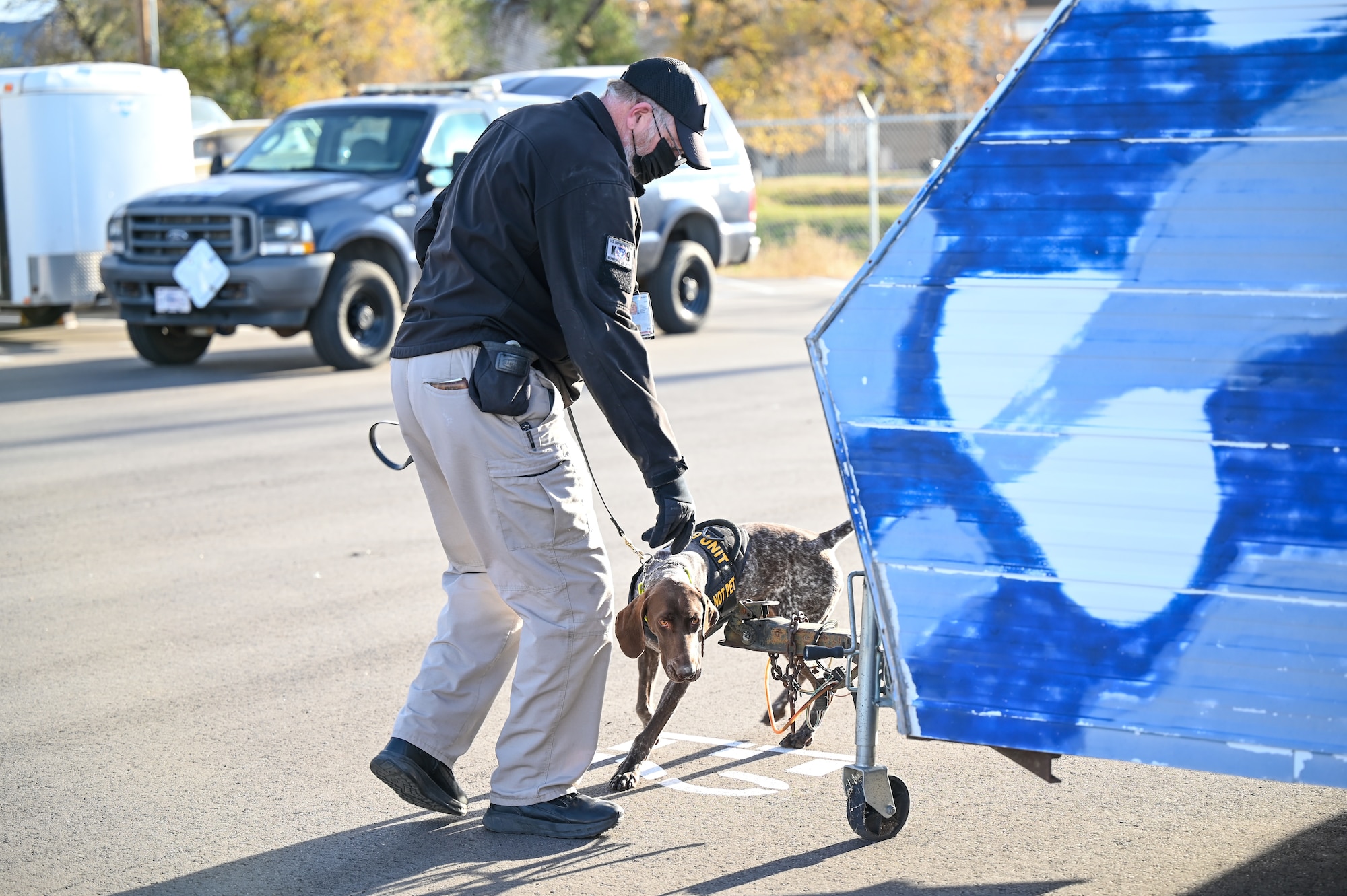 John Logie, K-9 handler from the Transportation Security Administration, and K-9 Bibi, search for a simulated explosive device Nov. 18, 2021, at Hill Air Force Base, Utah. Military working dogs and their handlers from 75th Security Forces Squadron conducted joint K-9 training with local, state and federal law enforcement dog teams to foster partner relations and enhance capabilities. (U.S. Air Force photo by Cynthia Griggs)