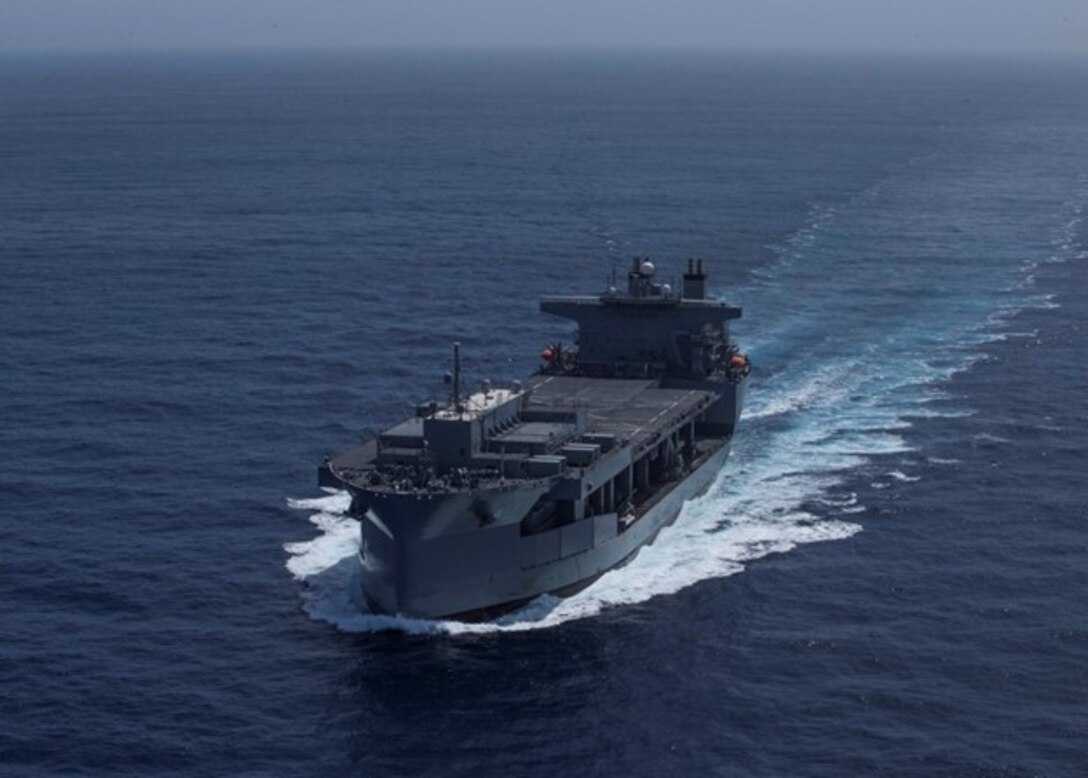 A U.S. Navy ship is underway in open waters.