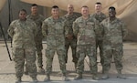 29th Infantry Division Soldiers who escorted vulnerable Afghans during Operation Allies Refuge pose for a photo shortly after the mission ended. The team drove more than 7,500 miles in 160 trips in support of the mission.