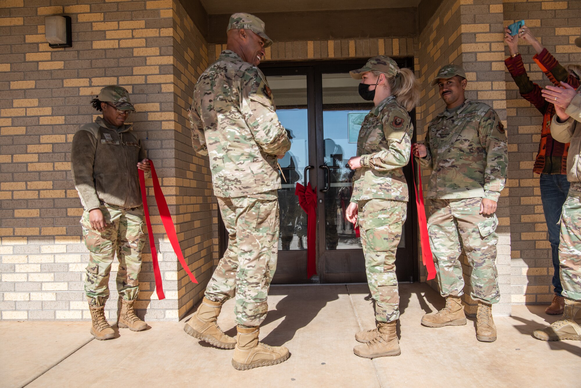 Col. Terence Taylor, 27th Special Operations Wing commander (center left) and Airman 1st Class Katheryn Cetrulo (center right), 27th Special Operations Force Support Squadron, participate in the ribbon cutting ceremony of the Airmen Ministry Center on Cannon Air Force Base, N.M., Nov. 17, 2021. The Airmen Ministry Center was established to build spiritually resilient Airmen at Cannon by developing an authentic community, promoting servant leadership, and providing service to others. (U.S. Air Force photo by Airman 1st Class Alexis Sandoval)