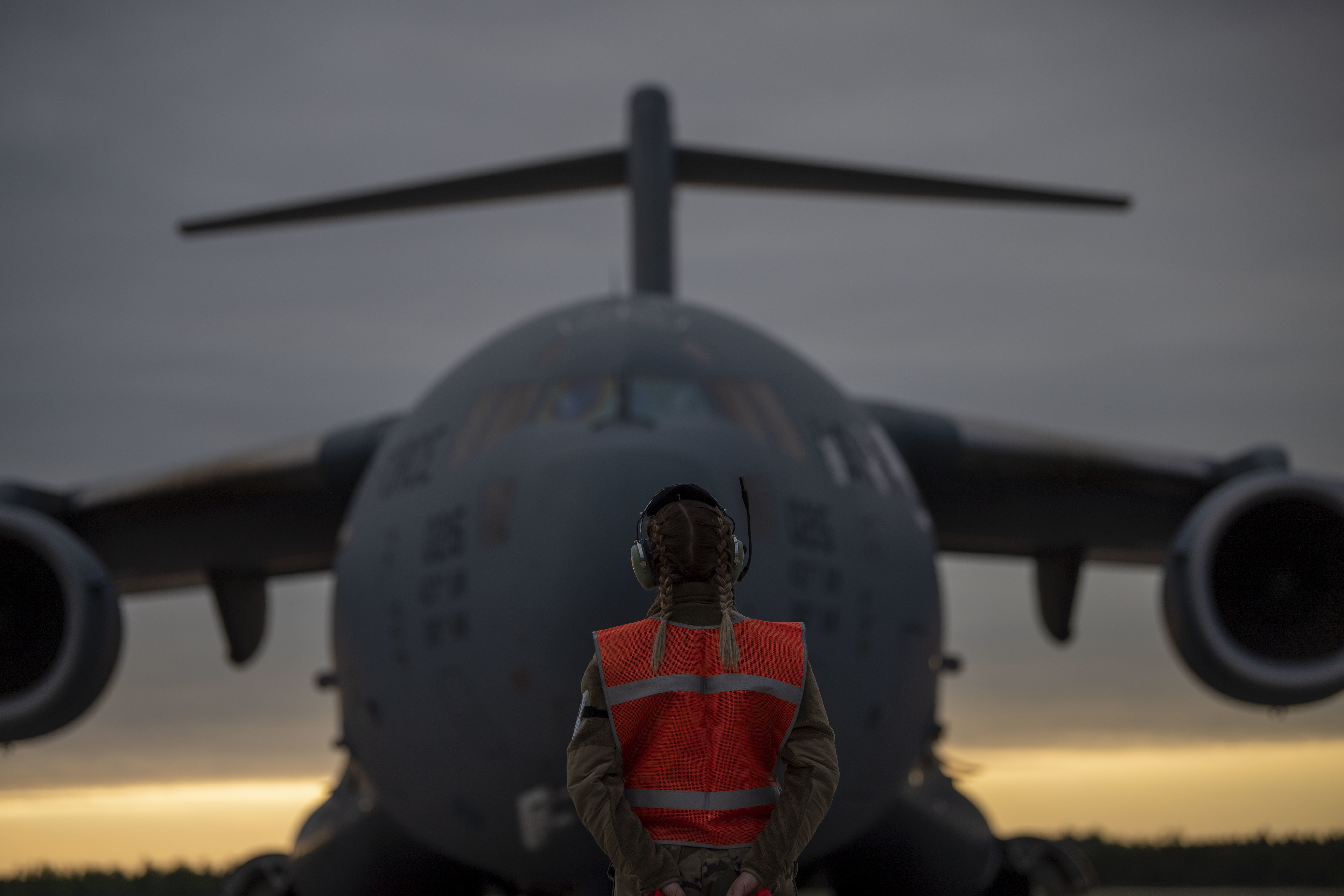 A U.S. Air Force C-17 Globemaster III crew chief prepares to marshal a C-17, May 24, 2021, at Alpena Combat Readiness Training Center, Michigan, in support of Mobility Guardian 2021.