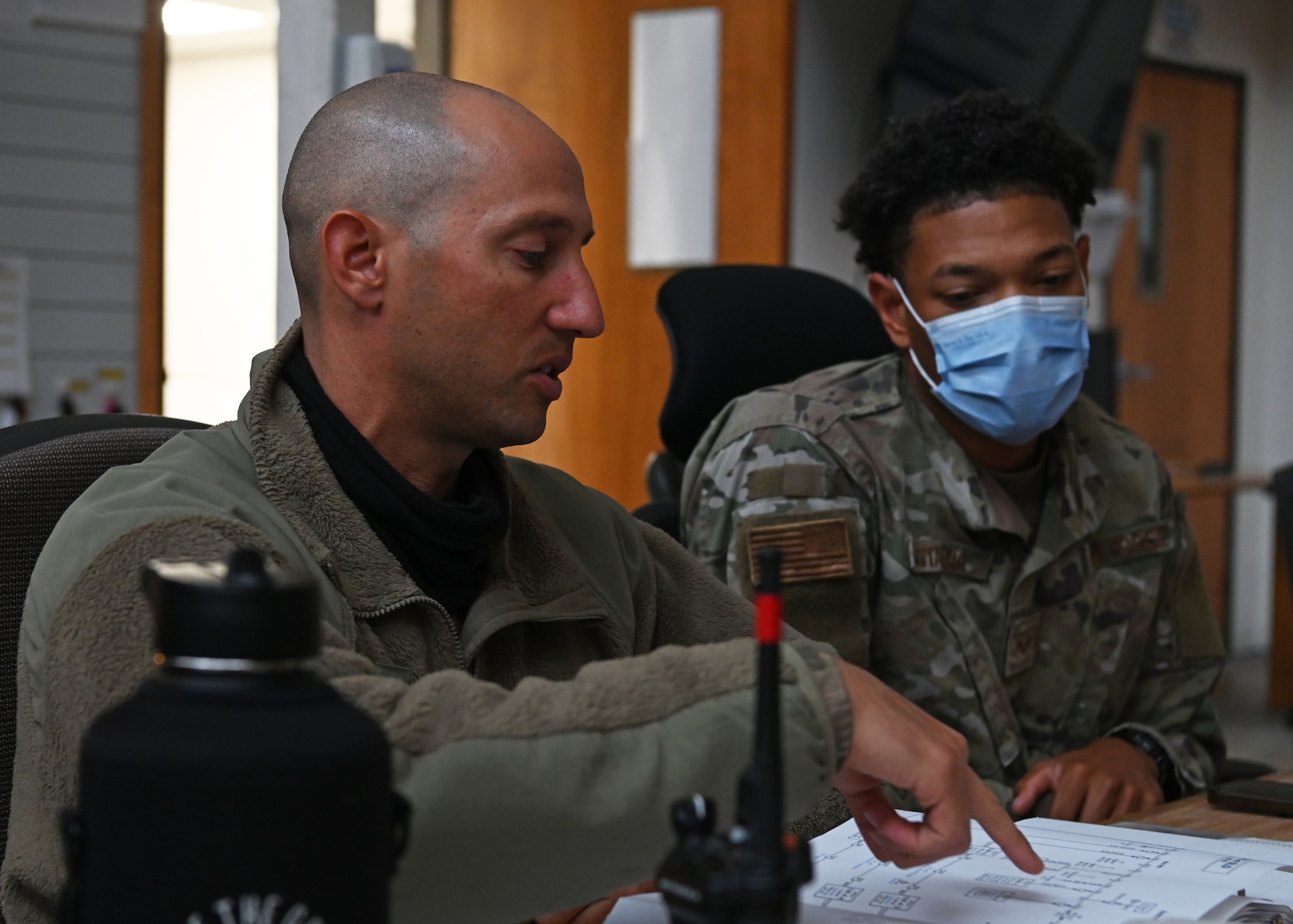 Tech. Sgt. David Livoti, 30th Civil Engineer Squadron electrical systems NCOIC, discusses mission planning with his team for projected maintenance on the South Base M-Line circuit on Nov. 9, 2021 at Vandenberg Space Force Base, Calif. Routine maintenance checks and repairs like these are conducted across the base to help ensure future and efficient distribution of power to Vandenberg. (U.S. Space Force photo by Staff Sergeant Draeke Layman)