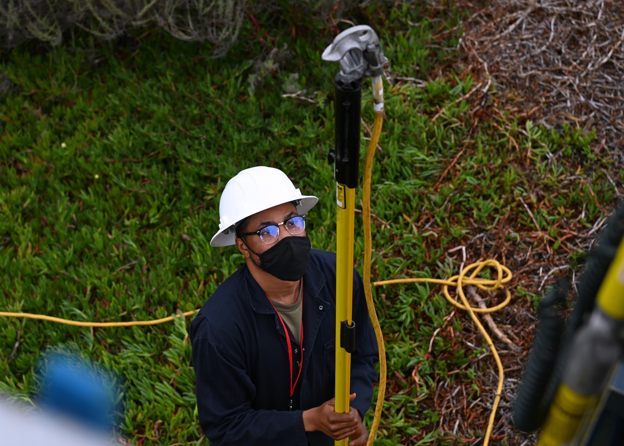 Airman 1st Class Bebito Tracey, 30th Civil Engineer Squadron electrical systems journeyman, prepares to hand-off a hot stick to begin setup for repairs on the South Base M-Line circuit on Nov. 9, 2021 at Vandenberg Space Force Base, Calif. Routine maintenance checks and repairs like these are conducted across the base to help ensure future and efficient distribution of power to Vandenberg. (U.S. Space Force photo by Staff Sergeant Draeke Layman)