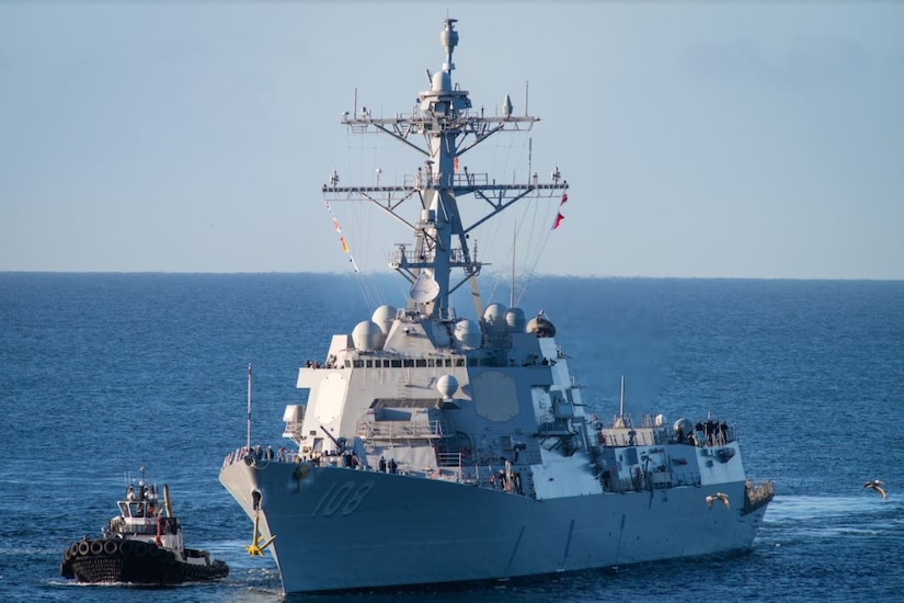 A military ship moves through the ocean