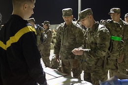 Soldiers talk before a march