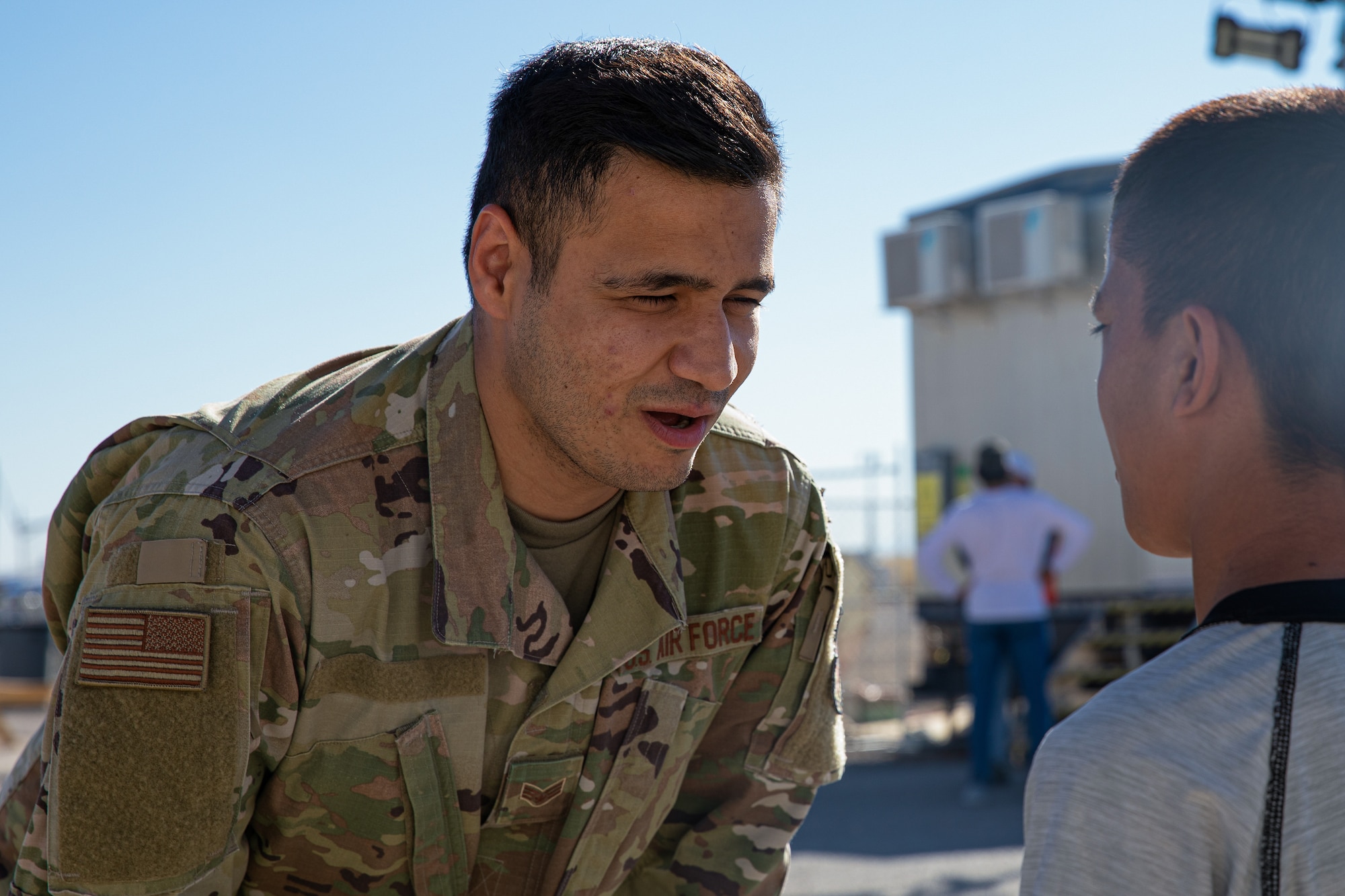 Photo of Senior Airman Kalimullah Ghorbandi, a linguist assigned to Task Force Holloman, interacting with an Afghan child at Aman Omid Village on Holloman Air Force Base.
