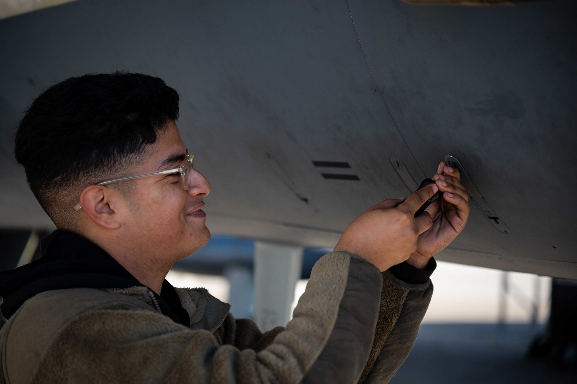 A maintainer from the 335th Fighter Generation Squadron closes a panel on an F-15E Strike Eagle as a part of Exercise Razon Talon at Seymour Johnson Air Force Base, North Carolina, Nov. 16, 2021. Razor Talon is a large force exercise that takes place on the East Coast of the United States. (U.S. Air Force photo by Senior Airman David Lynn)