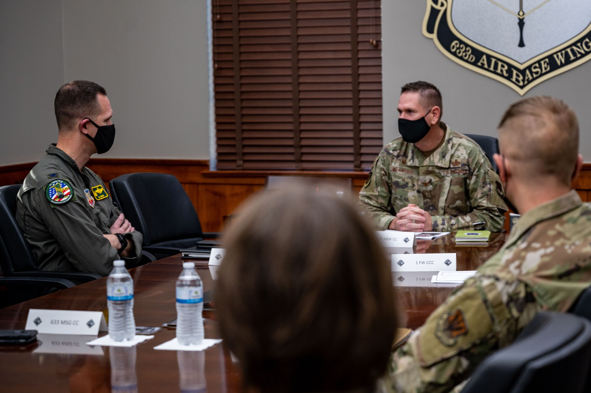 U.S. Air Force Col. Gregory Beaulieu, center, Joint Base Langley-Eustis commander, gives a mission briefing to Col. William Creeden, left, 1st Fighter Wing commander, at JBLE, Virginia, Nov. 18, 2021.