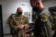 U.S. Air Force Tech. Sgt. Alan Carroll, 633d Security Forces Squadron combat arms training and maintenance instructor, gives an overview of the M18 pistol to Col. William Creeden, 1st Fighter Wing commander, at Joint Base Langley-Eustis, Virginia, Nov. 18, 2021.