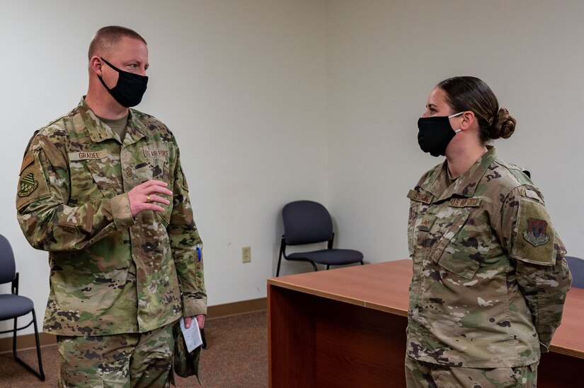 U.S. Air Force Chief Master Sgt. Christopher Gradel, 1st Fighter Wing command chief, asks a question to Staff Sgt. Hannah Stewart, 633d Logistics Readiness Squadron small air terminal supervisor, at Joint Base Langley-Eustis, Virginia, Nov. 18, 2021.
