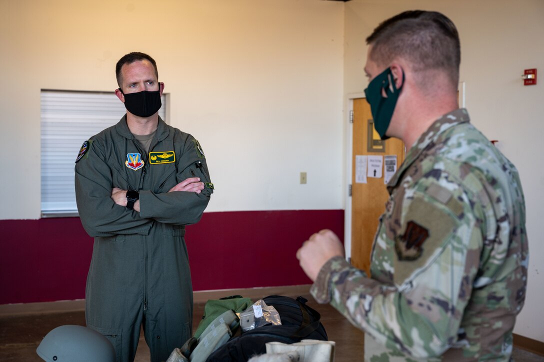 U.S. Air Force Col. William Creeden, left, 1st Fighter Wing commander, listens to a briefing from Tech. Sgt. Zachary Ballard, 633d Logistics Readiness Squadron noncommissioned officer in charge of individual protective equipment, at Joint Base Langley-Eustis, Virginia, Nov. 18, 2021.