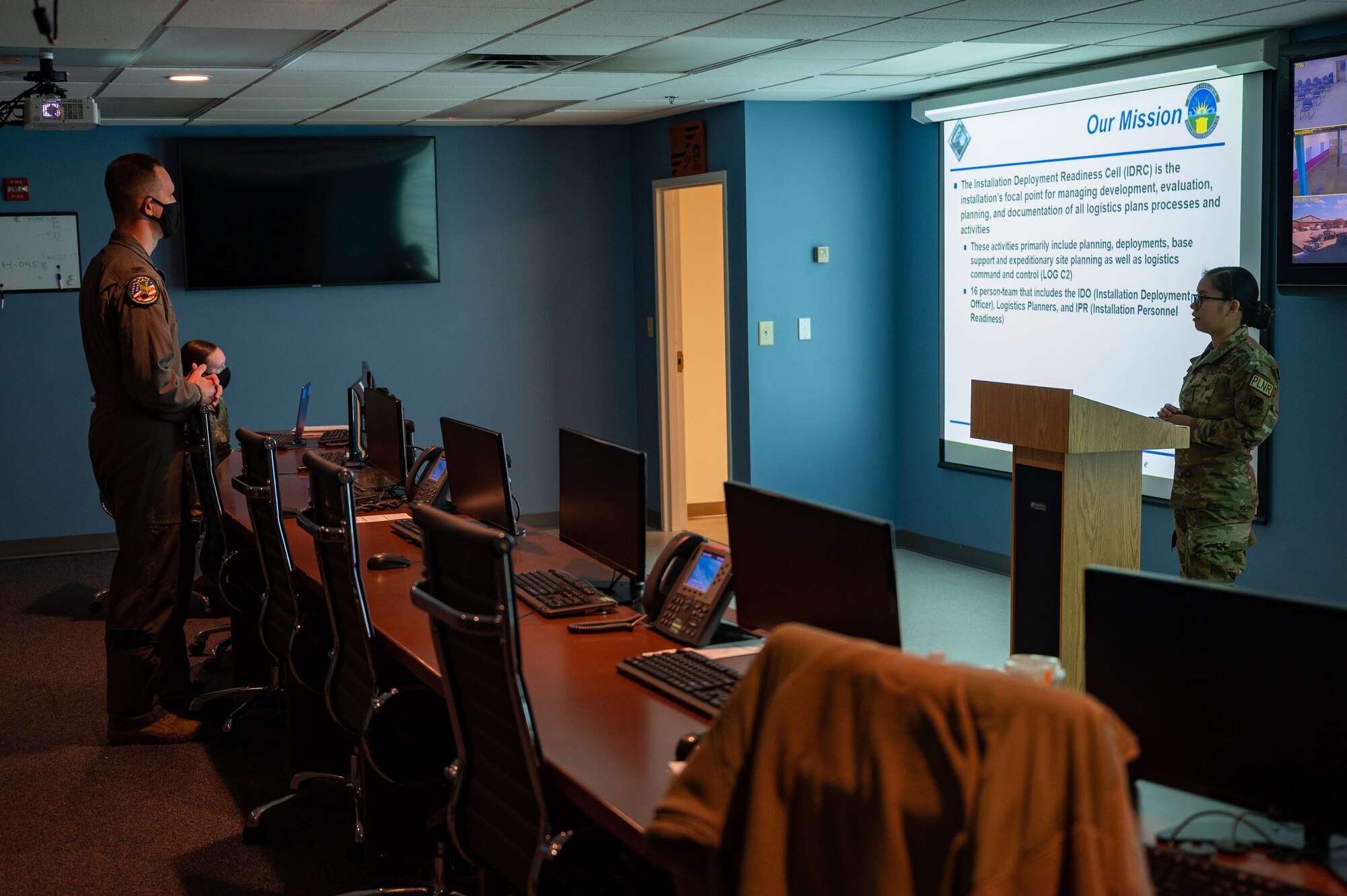 U.S. Air Force Airman 1st Class Jahairah Harrison, 633d Logistics Readiness Squadron logistics planner, briefs Col. William Creeden, 1st Fighter Wing commander, at Joint Base Langley-Eustis, Virginia, Nov. 18, 2021.