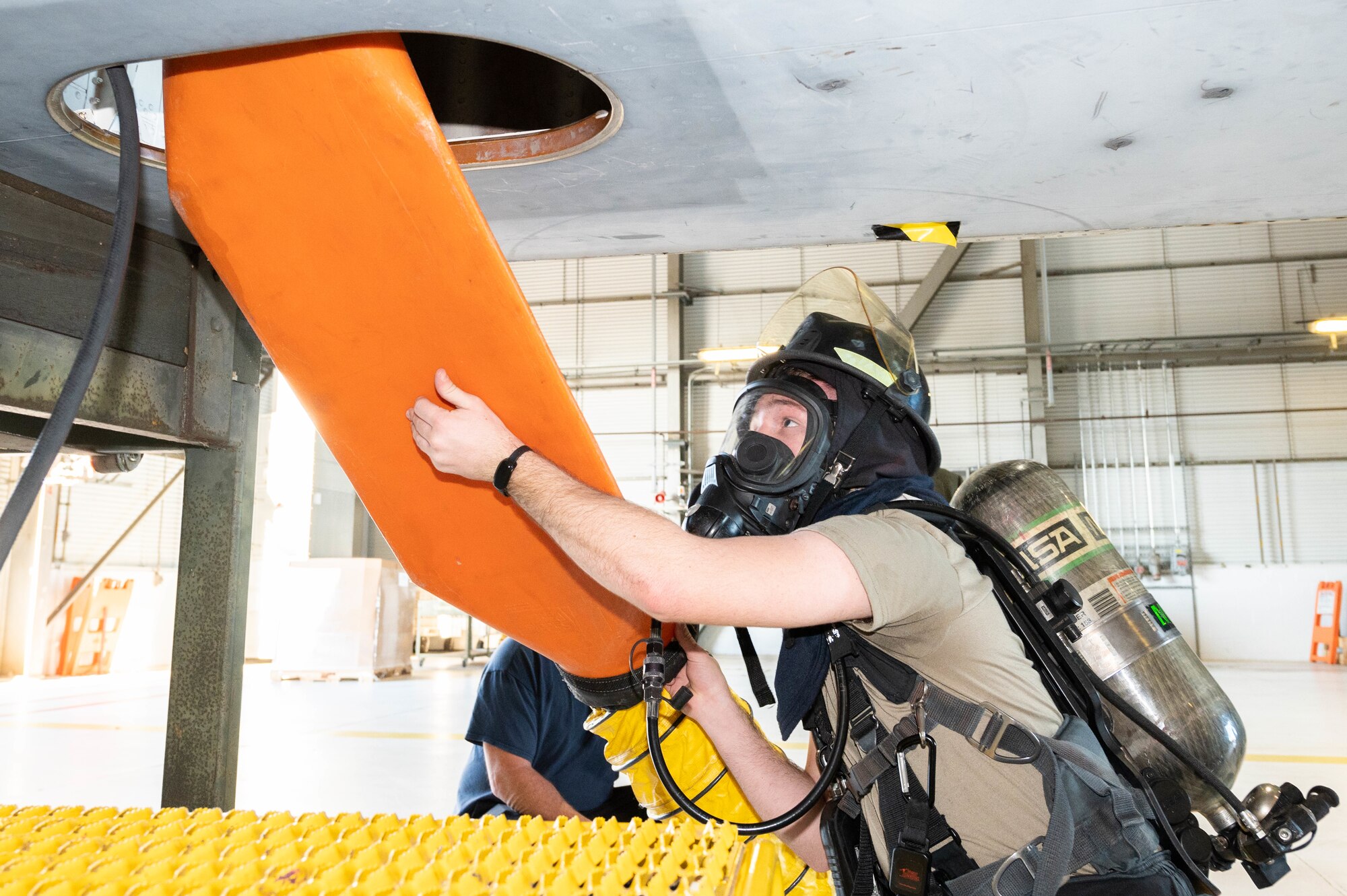 Airman Mason Jennings, 436th Civil Engineer Squadron fire protection apprentice, ventilates a fuel cell during an exercise at Dover Air Force Base, Delaware, Nov. 18, 2021. After ventilating the confined space, atmospheric readings are re-tested to determine if it is safe to rescue a simulated unresponsive Airman. (U.S. Air Force photo by Mauricio Campino)