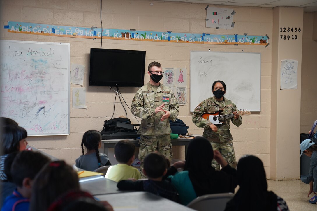 Service members assigned to Task Force Liberty teach Afghan students songs during class at Liberty Village as they support Operation Allies Welcome at Joint Base McGuire-Dix-Lakehurst, New Jersey, Oct. 28, 2021. The Department of Defense, through U.S. Northern Command, and in support of the Department of Homeland Security, is providing transportation, temporary housing, medical screening and general support for at least 50,000 Afghan evacuees at suitable facilities in permanent or temporary structures as quickly as possible. This initiative provides Afghan personnel essential support at secure locations outside of Afghanistan. (U.S. Air National Guard photo by Lt. Col. Candis Olmstead)