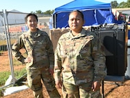 Alaska Air National Guard Staff Sergeants Sharon Queenie (left) and Judy Phommathep (right) assigned to the 176th Air Defense Squadron, Joint Base Elmendorf-Richardson, Alaska, pause for a photo during a break as public safety team members at TF Liberty Village 3, at Joint Base McGuire-Dix-Lakehurst, New Jersey, Sept. 19, 2021.  The Department of Defense, through U.S. Northern Command, and in support of the Department of Homeland Security, is providing transportation, temporary housing, medical screening, and general support for at least 50,000 Afghan evacuees at suitable facilities, in permanent or temporary structures, as quickly as possible. This initiative provides Afghan personnel essential support at secure locations outside Afghanistan. (National Guard photo by Master Sgt. John Hughel, Washington Air National Guard)