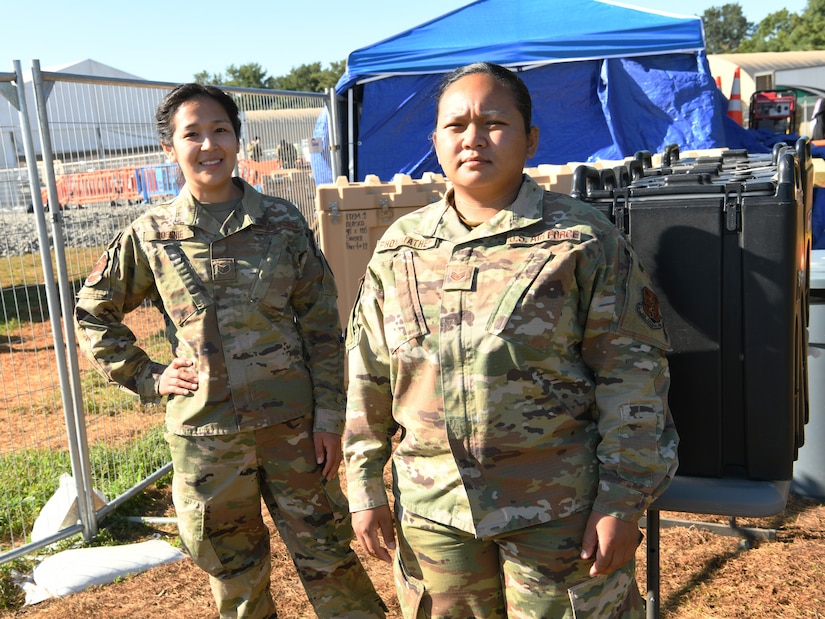 Alaska Air National Guard Staff Sergeants Sharon Queenie (left) and Judy Phommathep (right) assigned to the 176th Air Defense Squadron, Joint Base Elmendorf-Richardson, Alaska, pause for a photo during a break as public safety team members at TF Liberty Village 3, at Joint Base McGuire-Dix-Lakehurst, New Jersey, Sept. 19, 2021.  The Department of Defense, through U.S. Northern Command, and in support of the Department of Homeland Security, is providing transportation, temporary housing, medical screening, and general support for at least 50,000 Afghan evacuees at suitable facilities, in permanent or temporary structures, as quickly as possible. This initiative provides Afghan personnel essential support at secure locations outside Afghanistan. (National Guard photo by Master Sgt. John Hughel, Washington Air National Guard)