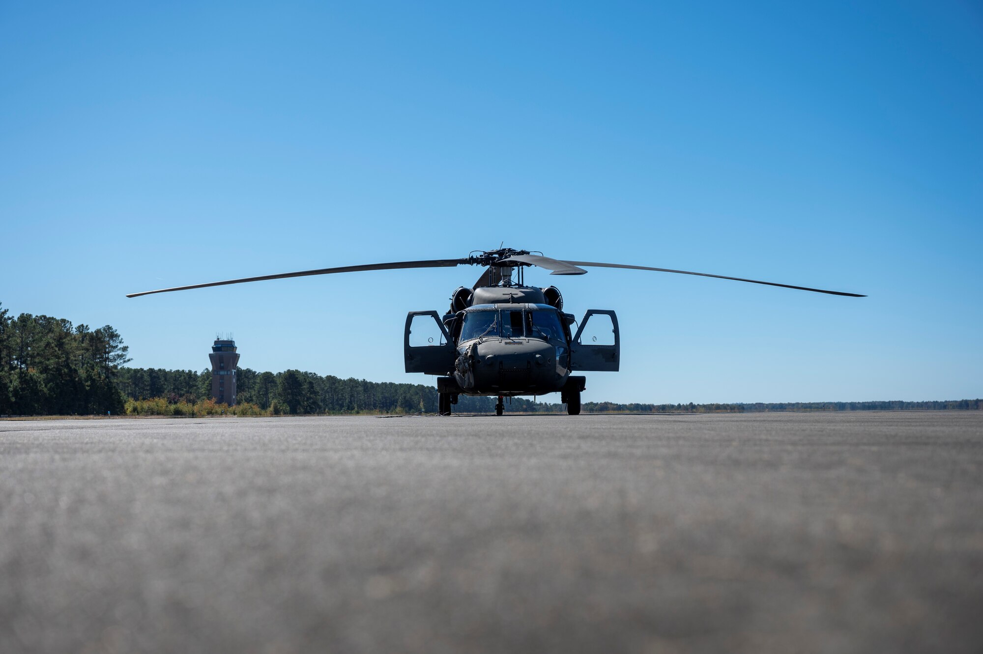 A photo of a UH-60 Blackhawk is parked on the flightline