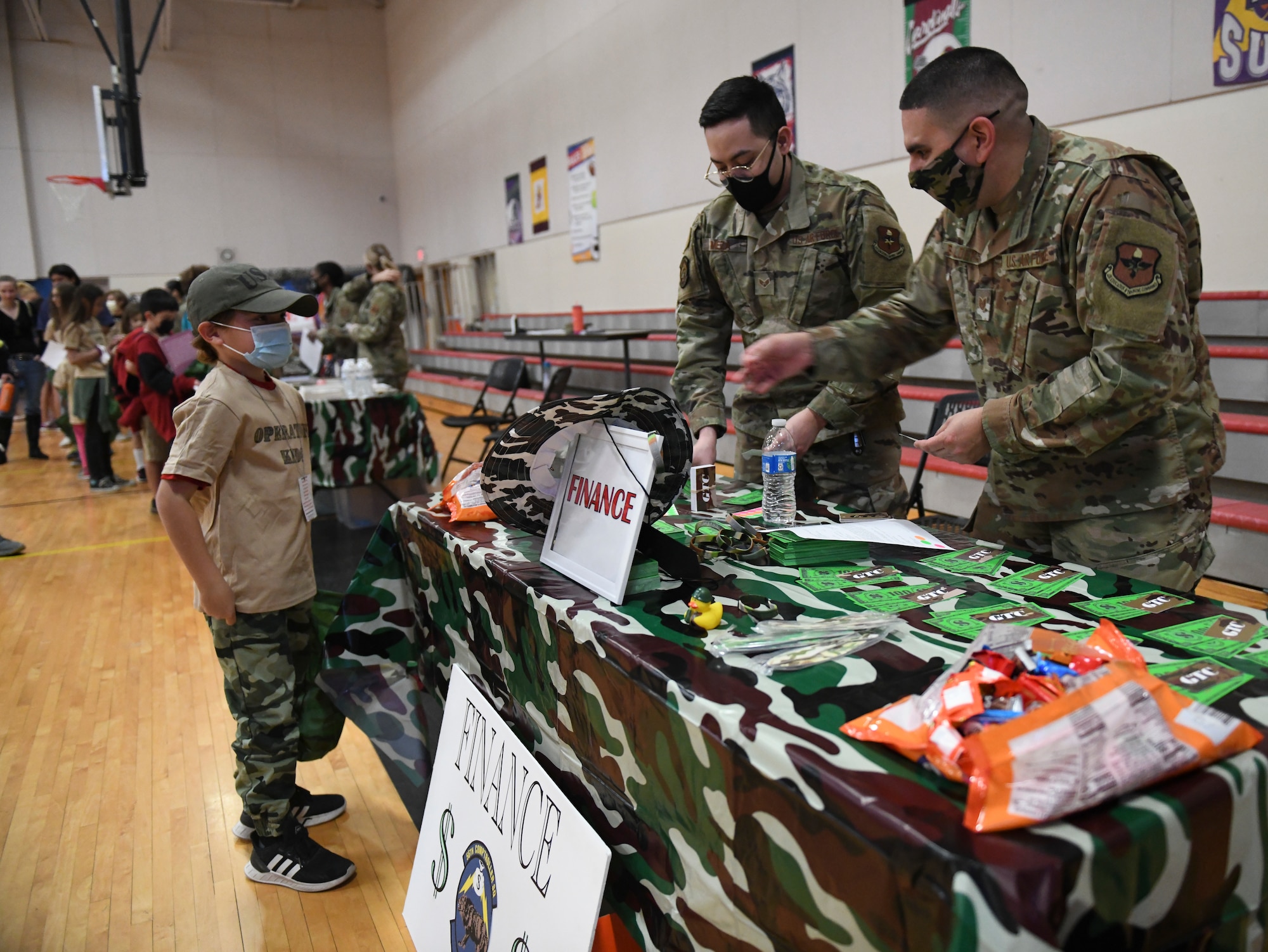 A military child receives a finance briefing as part of Operation Kids Investigating Deployment Services Nov. 13, 2021, at Luke Air Force Base, Arizona. Operation K.I.D.S. is an event that included a mock pre-deployment line with visits to finance, medical, the American Red Cross, key spouse and chapel personnel, as an imitation of what their parents experience prior to deploying. The Airman and Family Readiness Center takes care of Airmen and their families by providing educational resources and holding events such as Operation K.I.D.S., which gives children a better understanding of their parents’ sacrifice and dedication, and allows a dialog within families about deployments. (U.S. Air Force photo by Tech. Sgt. Amber Carter)