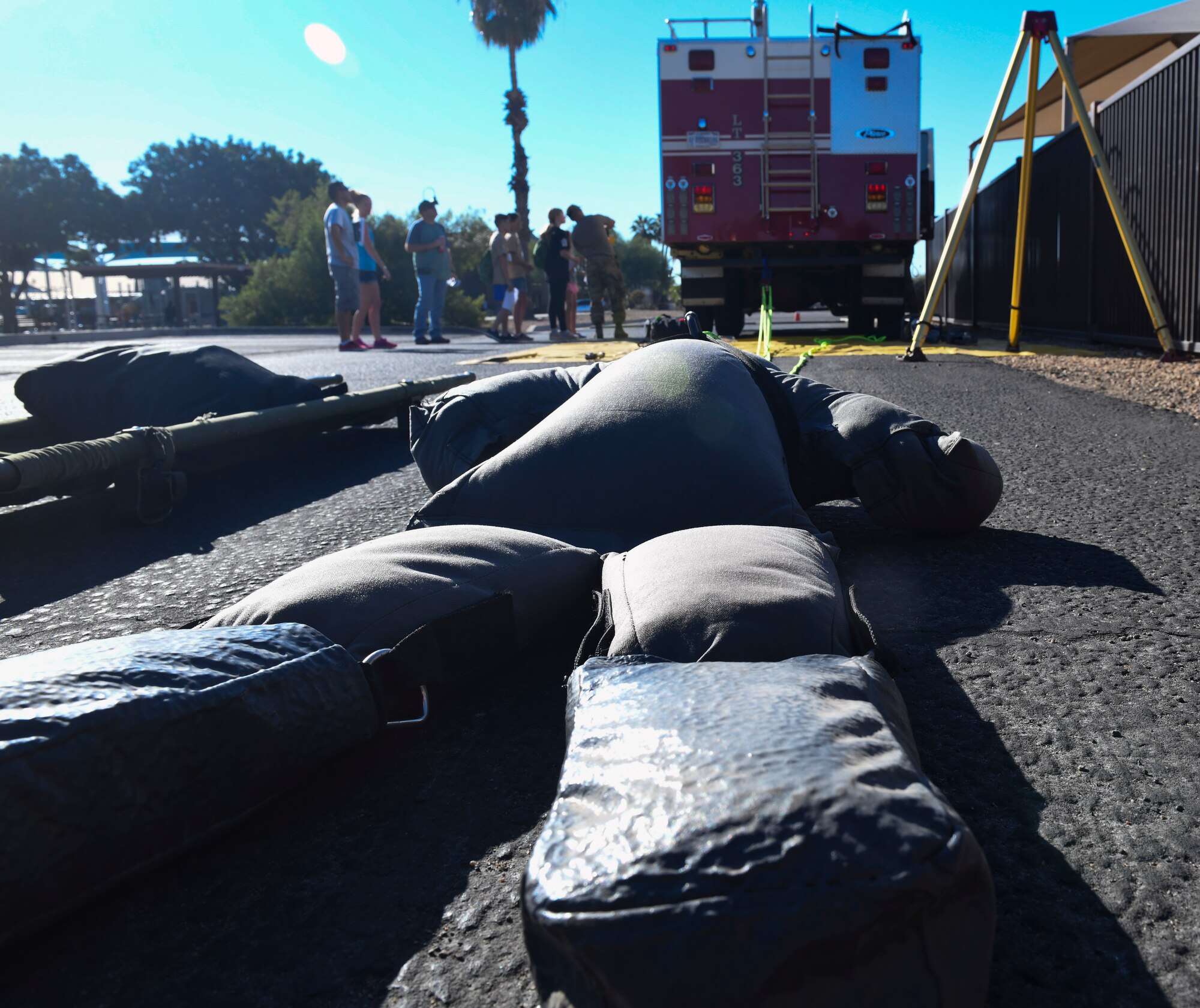 Airmen from the 56th Civil Engineer Squadron fire department inform military children about what it takes to be a firefighter during Operation Kids Investigating Deployment Services Nov. 13, 2021, at Luke Air Force Base, Arizona. Operation K.I.D.S. had similar aspects of a deployment within a simulated deployed location and included information booths with unit representatives from readiness, fire department, security forces, and aircraft maintenance.  The Airman and Family Readiness Center takes care of Airmen and their families by providing educational resources and holding events such as Operation K.I.D.S., which gives children a better understanding of their parents’ sacrifice and dedication, and allows a dialog within families about deployments. (U.S. Air Force photo by Tech. Sgt. Amber Carter)