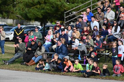 A crowd of Brent Elementary School parents and students applauds the United States Air Force Honor Guard Drill Team during their performance on Joint Base Anacostia-Bolling, Washington, D.C., Nov. 6, 2021. U.S. Air Force, Army and Coast Guard members held demonstrations for the military and civilian students to learn about military customs and courtesies while increasing their understanding of the military lifestyle. The drill team performed during an event hosted by JBAB for Brent Elementary School students and families to immerse them into military and civilian lifestyles. (U.S. Air Force photo by Airman 1st Class Anna Smith)