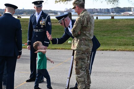 Members of the United States Air Force Honor Guard Drill Team interact with a Brent Elementary student following the drill team’s performance at a military immersion event on Joint Base Anacostia-Bolling, Washington, D.C., Nov. 6, 2021. U.S. Air Force, Army and Coast Guard members held demonstrations for the military and civilian students to learn about military customs and courtesies while increasing their understanding of the military lifestyle. Military and civilian students and families from the off-base D.C. school attended this event to experience military customs. (U.S. Air Force photo by Airman 1st Class Anna Smith)