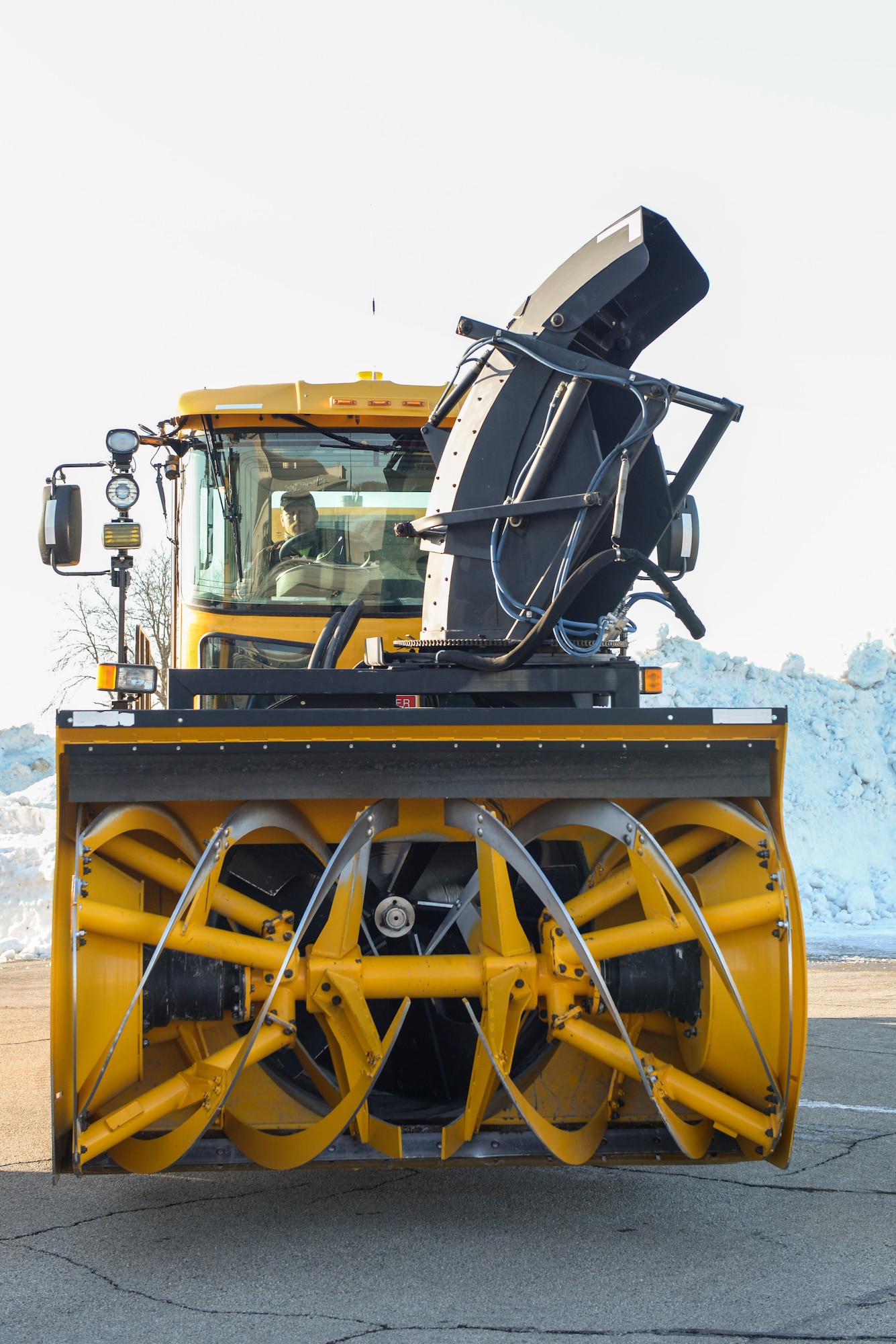 A snow blower belonging to the 88th Civil Engineer Squadron snow removal team sits parked and ready on the airfield of Wright-Patterson Air Force Base, Ohio, Feb. 23, 2020. From November to April the team runs 24-hour operations with as many as 30 pieces of equipment to ensure the mission of Wright-Patt can continue. (U.S. Air Force photo by Wesley Farnsworth)