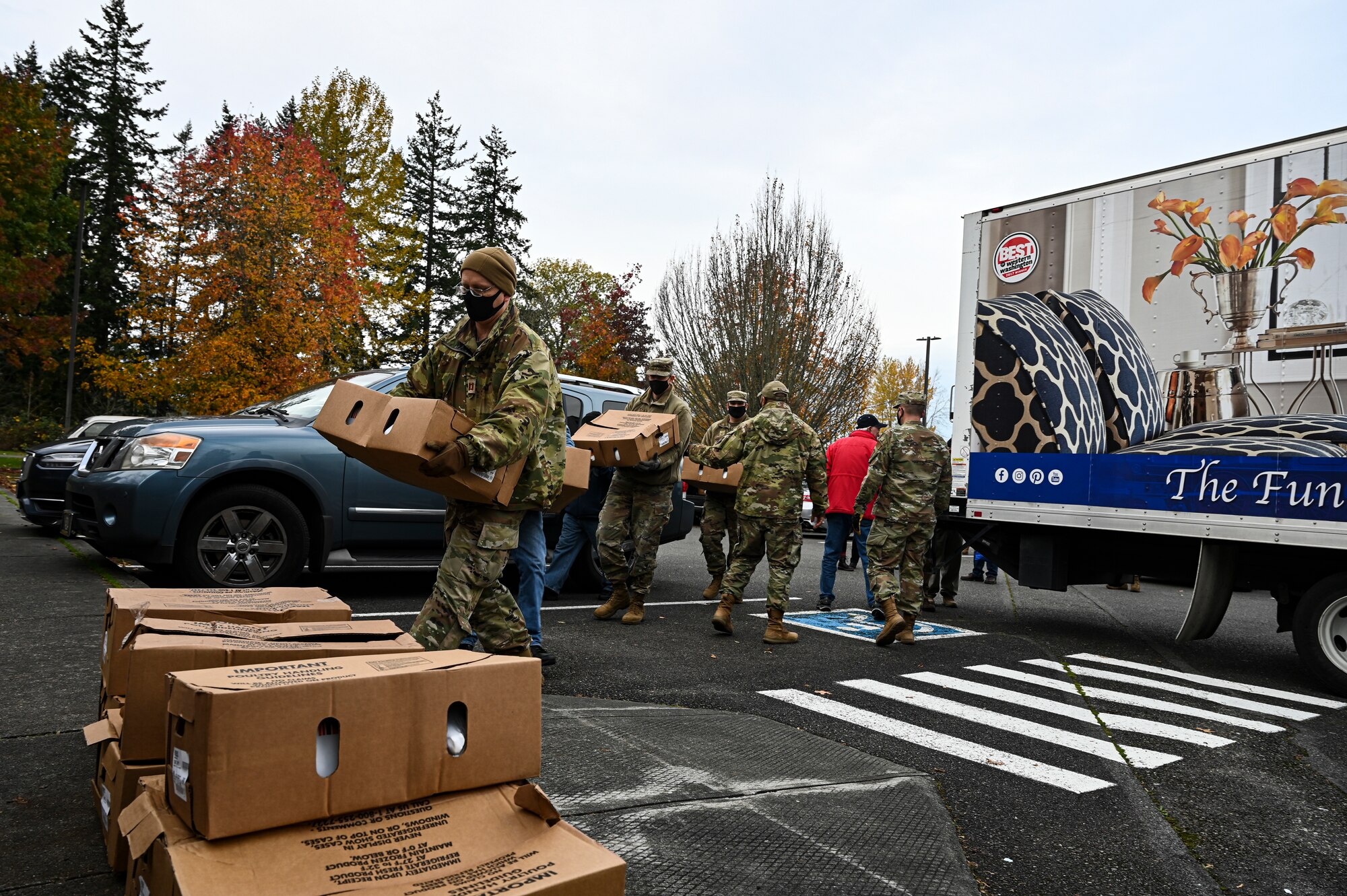 U.S. Air Force Airmen with Team McChord and volunteers from the local community help distribute turkeys during Operation Turkey Drop at Joint Base Lewis-McChord, Wash., Nov. 18, 2021. The Air Force Association McChord Field Chapter and the Pierce Military and Business Alliance organized the drop of more than 300 turkeys to Airmen at Joint Base Lewis-McChord for the Thanksgiving holiday. (U.S. Air Force photo by Master Sgt. Julius Delos Reyes)