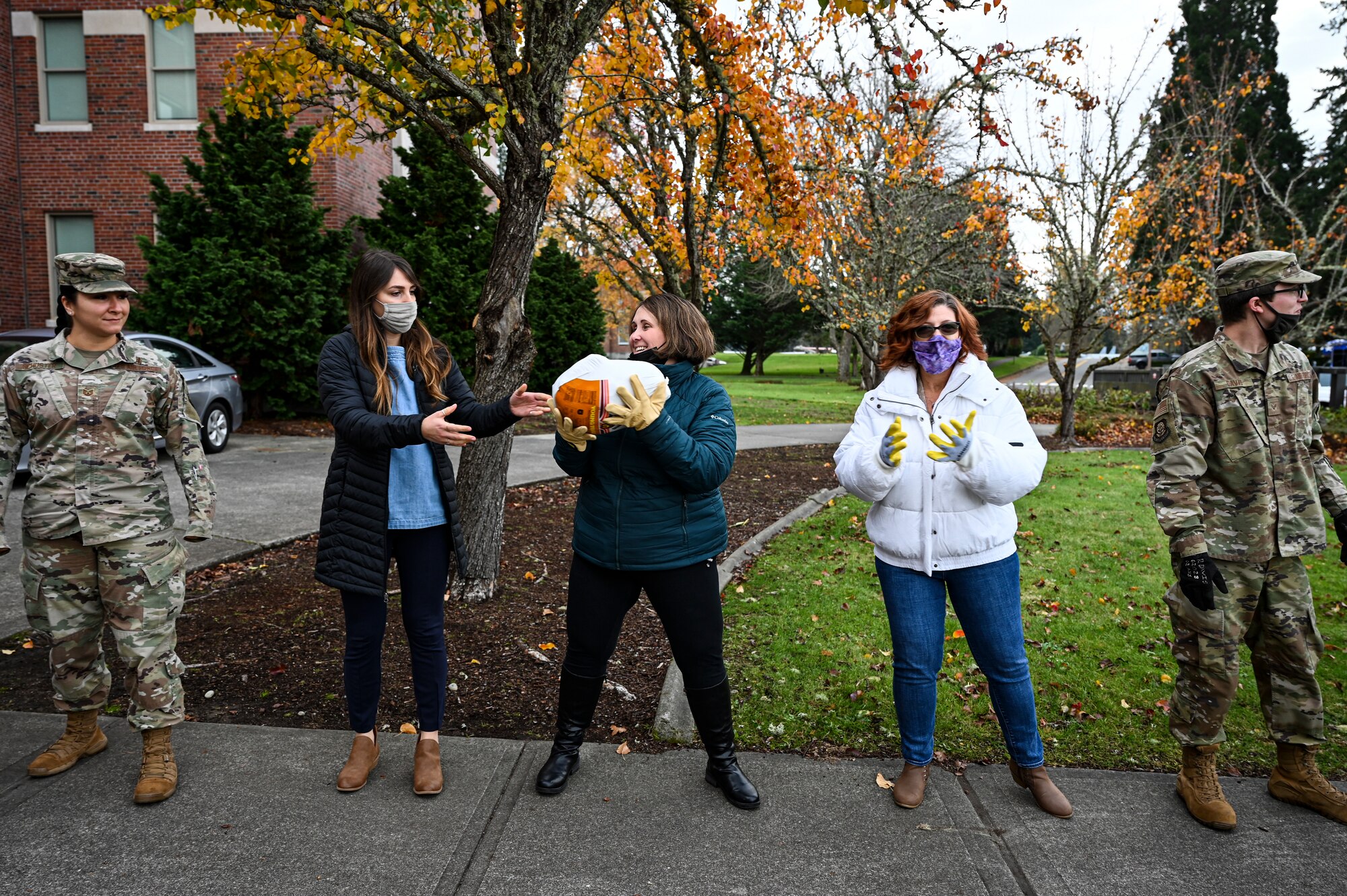 U.S. Air Force Airmen with Team McChord and volunteers from the local community help distribute turkeys during Operation Turkey Drop at Joint Base Lewis-McChord, Wash., Nov. 18, 2021. The Air Force Association McChord Field Chapter and the Pierce Military and Business Alliance organized the drop of more than 300 turkeys to Airmen at Joint Base Lewis-McChord for the Thanksgiving holiday. (U.S. Air Force photo by Master Sgt. Julius Delos Reyes)