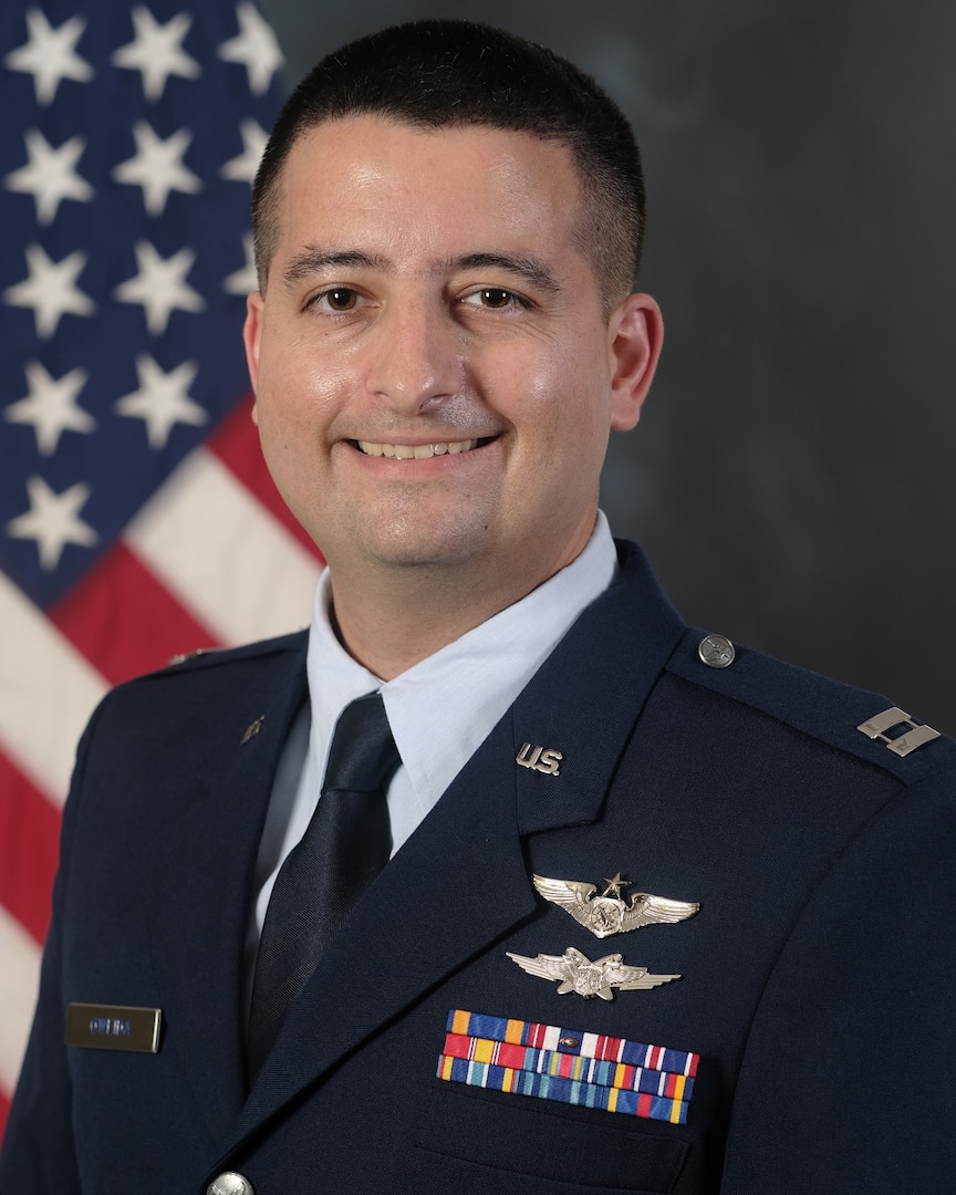 photo of Official photo of Capt. Ryan Oweida with U.S. Flag in background