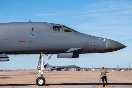 Master Sgt. Lucas Kinney, 489th Maintenance Squadron active reserve technician crew chief, waits to place chocks under a B-1B Lancer that returned to Dyess Air Force Base, Texas, Nov. 15, 2021, from a Bomber Task Force Europe deployment.