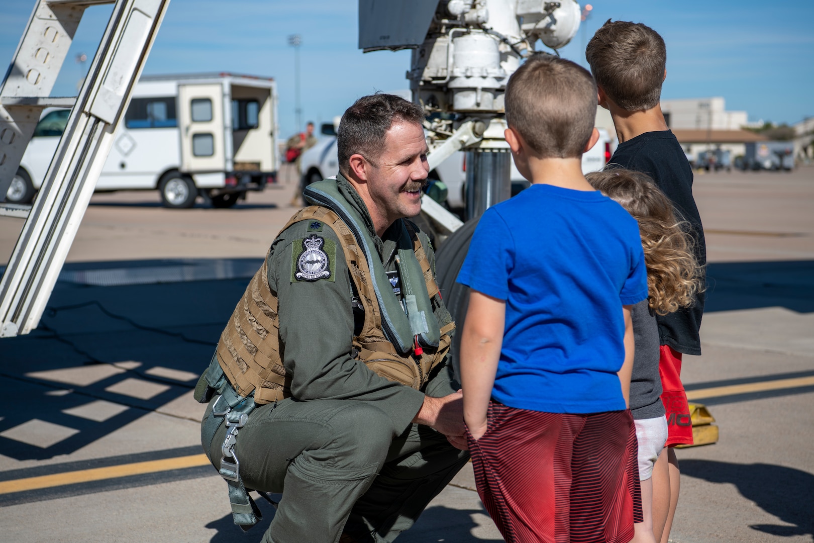 Lt. Col. Brian Boland, 345th Bomb Squadron pilot, greets his children after returning to Dyess Air Force Base, Texas, Nov. 15, 2021, from a Bomber Task Force Europe deployment.