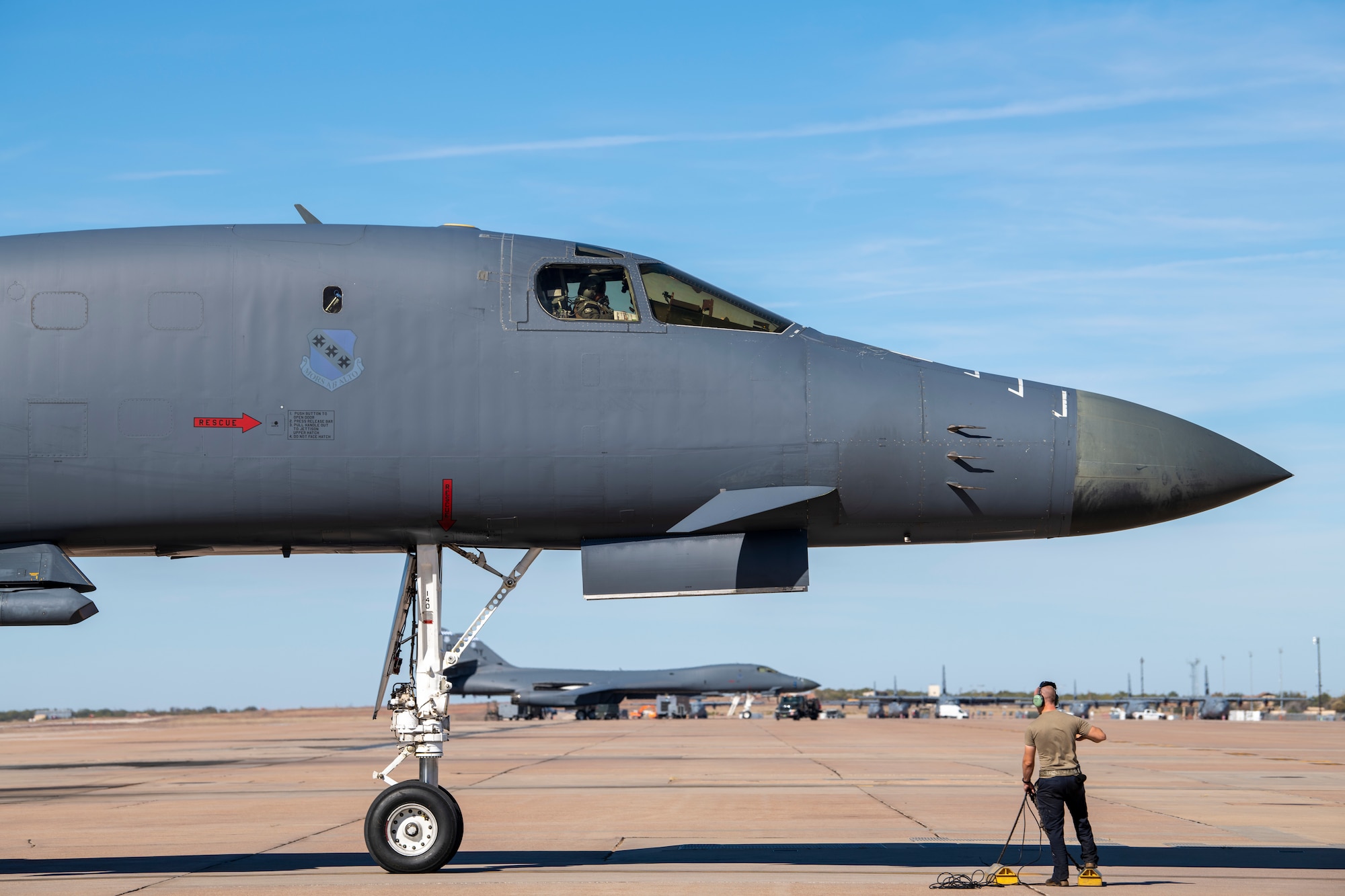 Master Sgt. Lucas Kinney, 489th Maintenance Squadron active reserve technician crew chief, waits to place chocks under a B-1B Lancer that returned to Dyess Air Force Base, Texas, Nov. 15, 2021, from a Bomber Task Force Europe deployment.