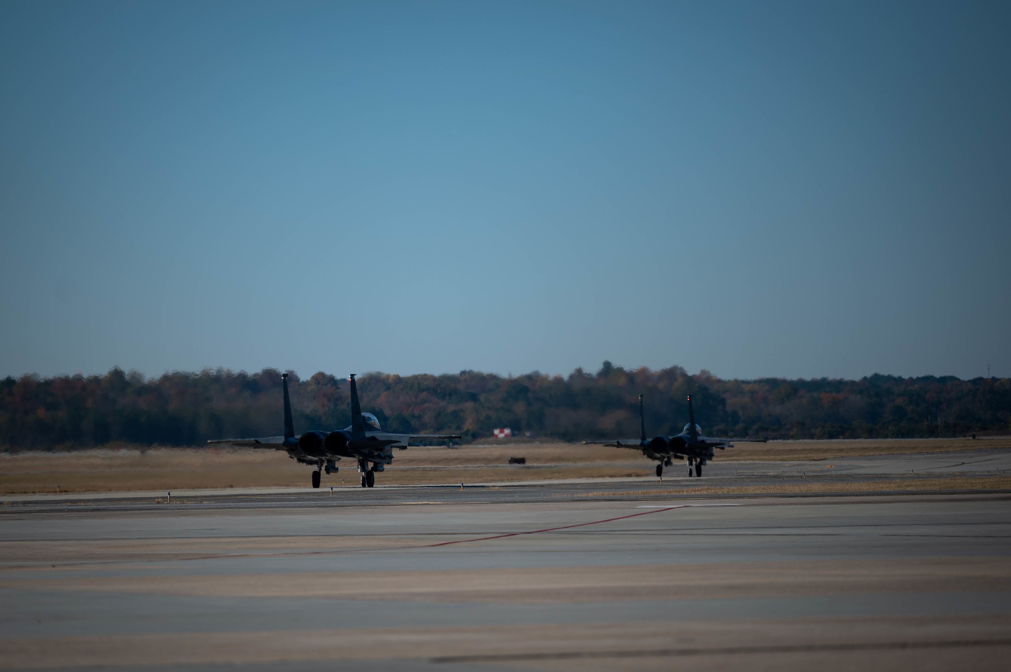 Two F-15E Strike Eagles from the 335th Fighter Generation Squadron taxi to the runway as a part of Razor Talon at Seymour Johnson Air Force Base, North Carolina, Nov. 16, 2021. Razor Talon is a 4th Fighter Wing-led joint exercise. (U.S. Air Force photo by Senior Airman David Lynn)