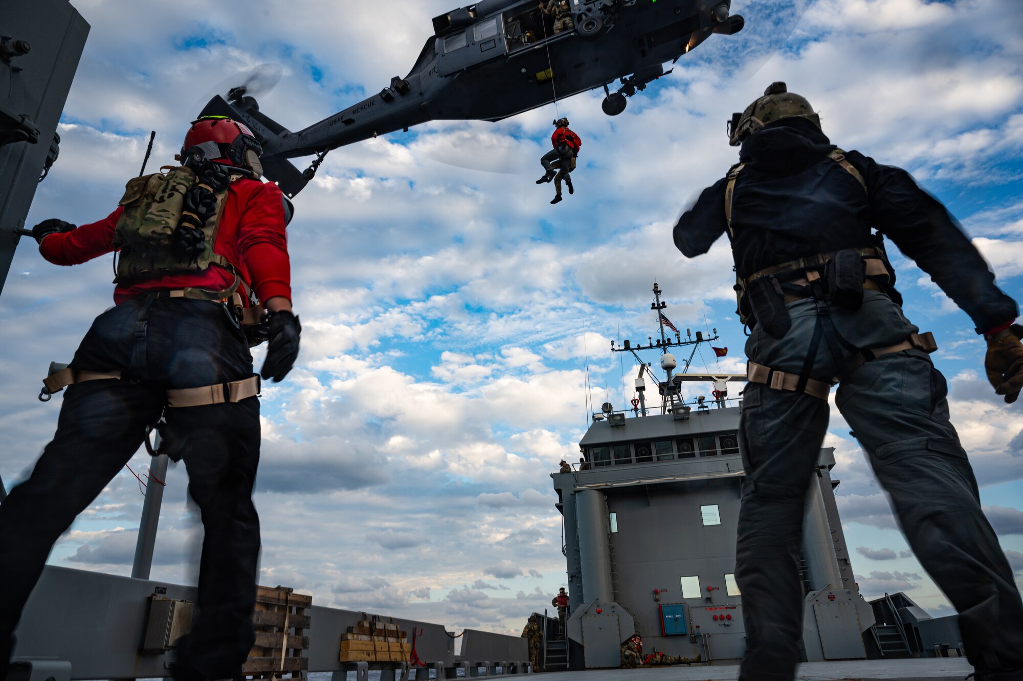 Airmen observe hoist training.