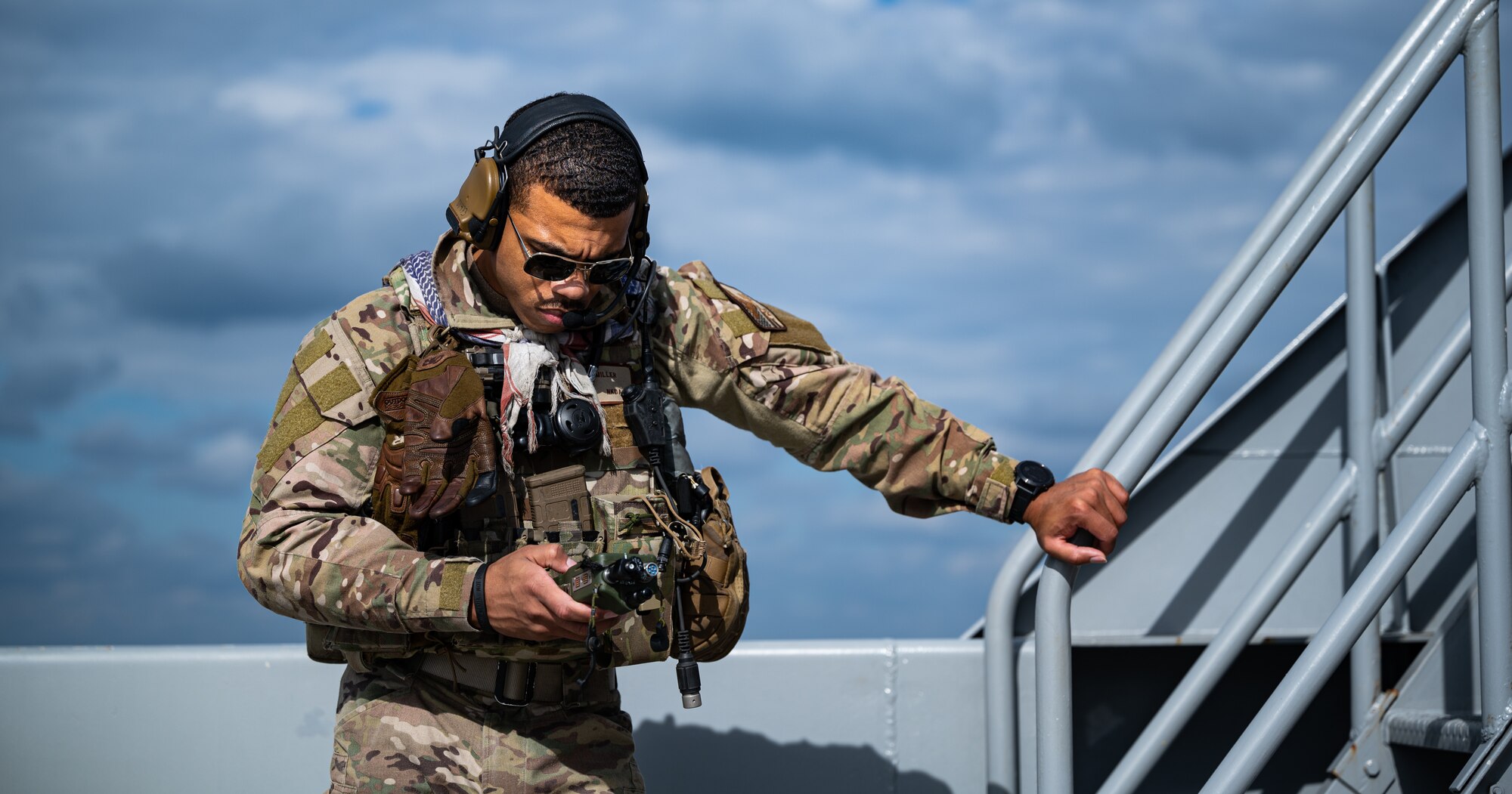 An Airman communicates with a helicopter.