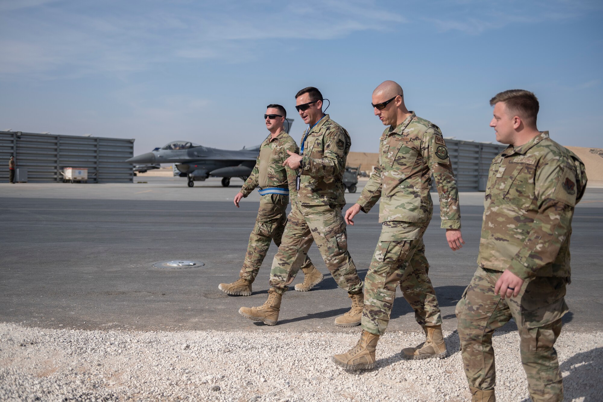 U.S. Airmen with the 55th Expeditionary Fighter Generation Squadron speak with Chief Master Sgt. Sean Milligan, middle right, 332nd Air Expeditionary Wing command chief, Nov. 13, 2021, at an undisclosed location somewhere in Southwest Asia. The 55th EFGS store and inspect equipment for five maintenance sections responsible for maintaining F-16C Fighting Falcons. (U.S. Air Force photo by Senior Airman Cameron Otte)