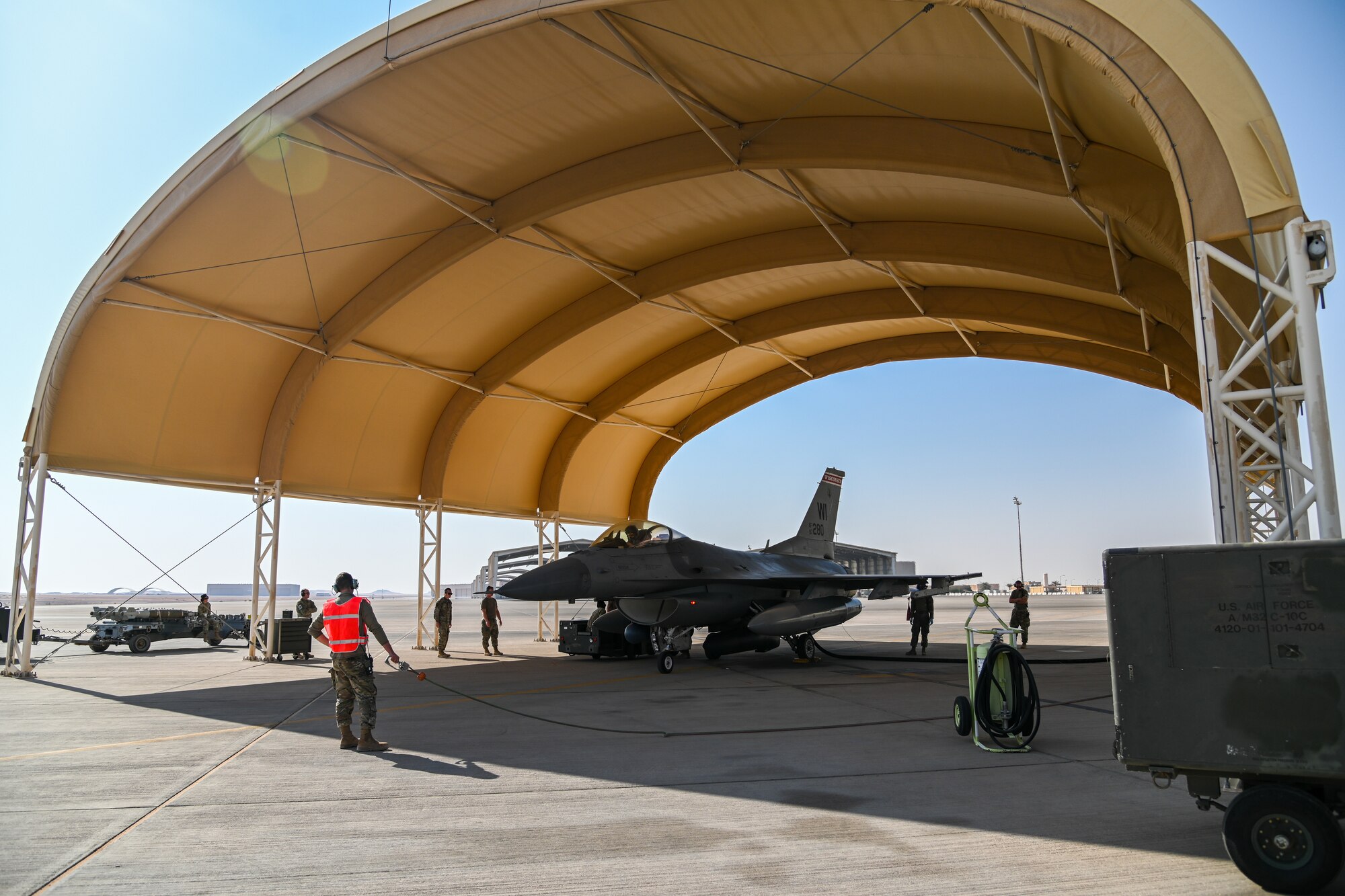 Airmen from the 176th Expeditionary Fighter Generation Squadron and the 176th Expeditionary Fighter Squadron perform an Integrated Combat Turn at Prince Sultan Air Base, Kingdom of Saudi Arabia, Nov. 18, 2021. Performing ICTs allows the aircrew to spend less time on the ground and increases the time they can fly supporting operations. (U.S. Air Force photo by Staff Sgt. Christina Graves)