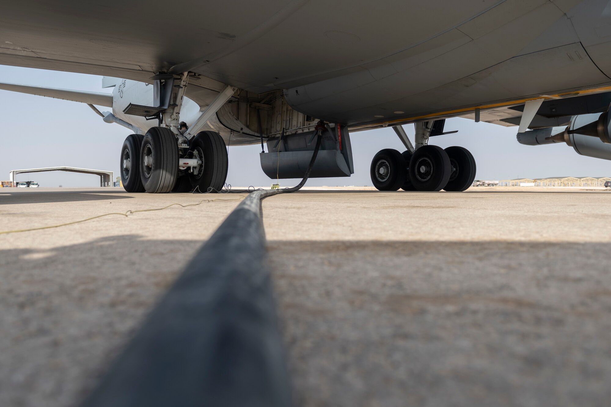 An R-11 fuel truck pumps fuel into a KC-135 Stratotanker