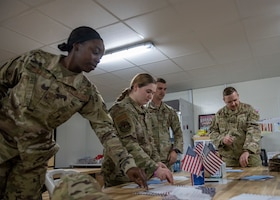 U.S. Airmen with the 332nd Air Expeditionary Wing distribute letters