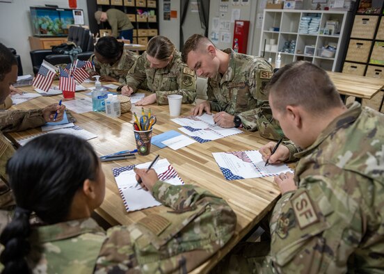 U.S. Airmen with the 332nd Air Expeditionary Wing distribute letters