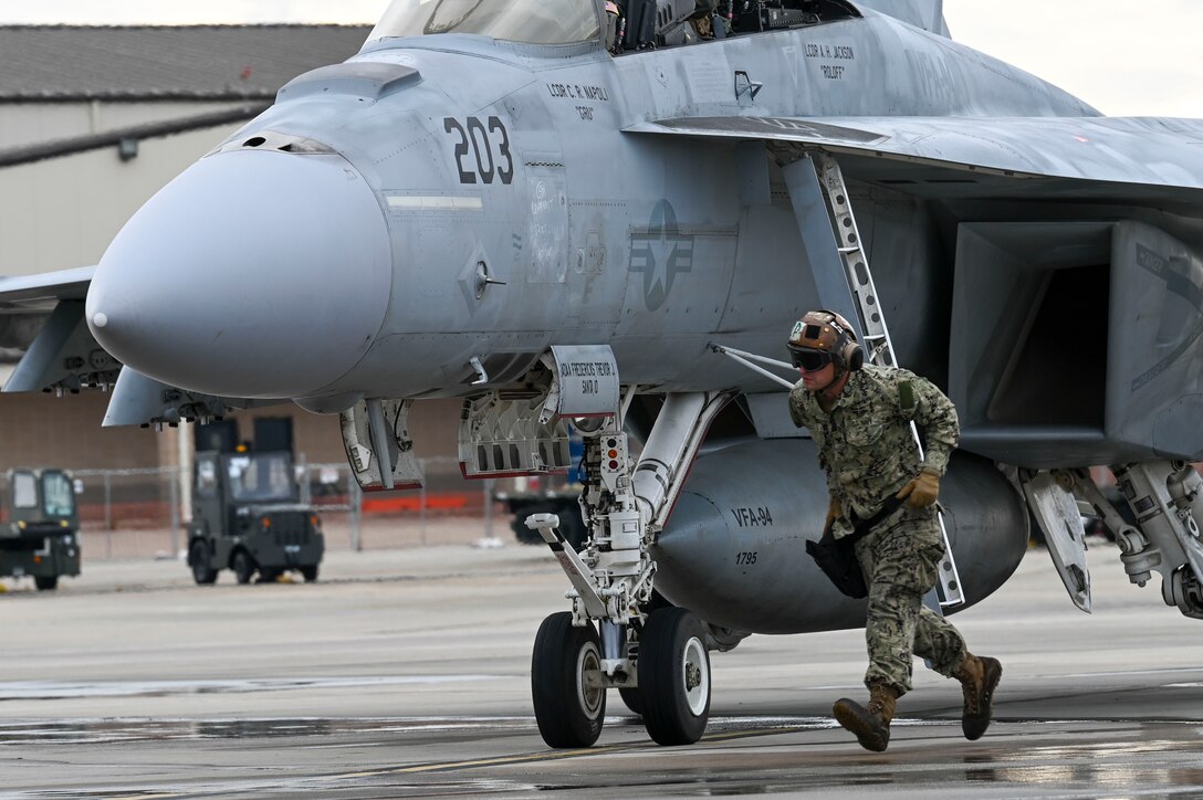 A Sailor recovers an F-18