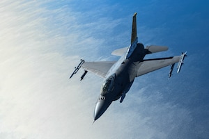 F-16 flies over water
