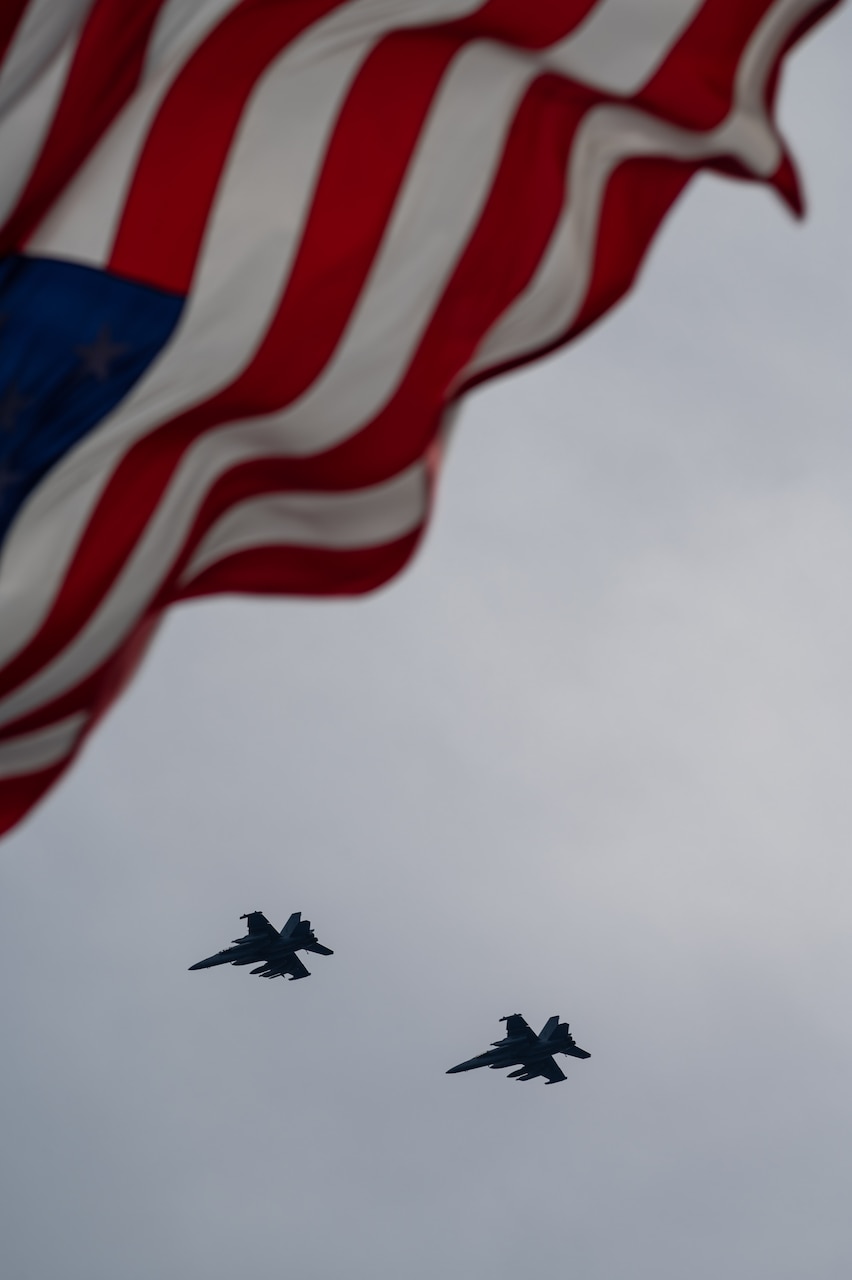 Two EA-18G Growlers, assigned to the “Gauntlets” of Electronic Attack Squadron (VAQ) 136, fly over Nimitz-Class aircraft carrier USS Carl Vinson (CVN 70) during Annual Exercise (ANNUALEX) 2021. ANNUALEX 2021 is a multilateral exercise conducted by elements of the Royal Australian, Royal Canadian, German, Japan Maritime Self-Defense Force and U.S. navies to demonstrate naval inoperability and a joint commitment to a free, open and inclusive Indo-Pacific.