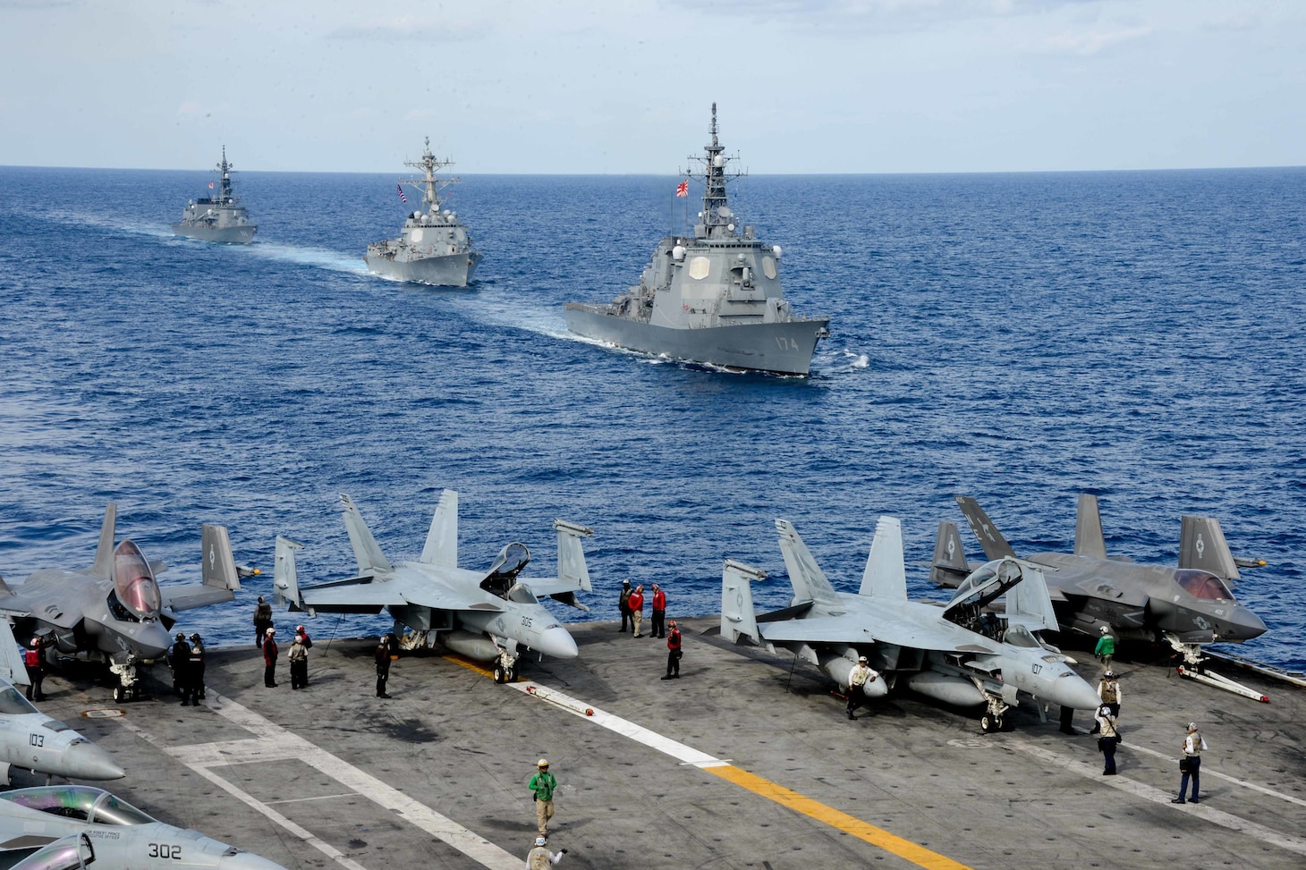 PHILIPPINE SEA (Nov. 21, 2021) Japan Maritime Self-Defense Force (JMSDF) Kongo-class guided-missile destroyer JS Kirishima (DDG 174), U.S. Arleigh Burke-class guided-missile destroyer USS Stockdale (DDG 106) and JMSDF Takanami-class destroyer JS Onami (DD 111) sail alongside Nimitz-Class aircraft carrier USS Carl Vinson (CVN 70) during Annual Exercise (ANNUALEX) 2021. ANNUALEX 2021 is a multilateral exercise conducted by elements of the Royal Australian, Royal Canadian, German, JMSDF and U.S. navies to demonstrate naval inoperability and a joint commitment to a free, open and inclusive Indo-Pacific.(U.S. Navy photo by Mass Communication Specialist Seaman Apprentice Joshua Sapien)