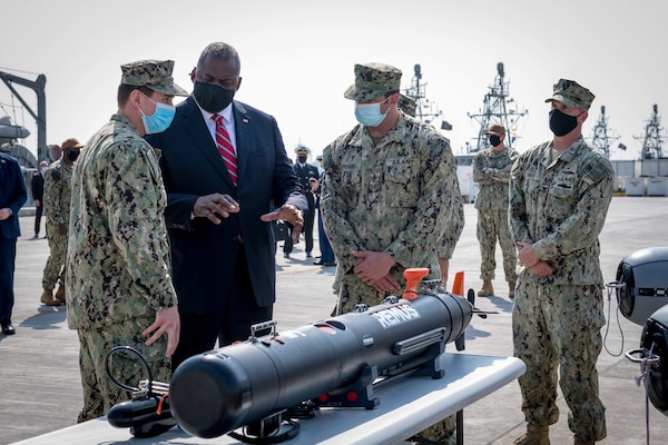 Secretary of Defense Lloyd J. Austin speaks to U.S. Navy personnel assigned to Commander, Task Force (CTF) 52 about a Mark 18 Mod 2 underwater unmanned vehicle, at Naval Support Activity Bahrain, Nov. 21. TF 52 provides command and control of all mine warfare assets in the U.S. 5th Fleet area of operations.