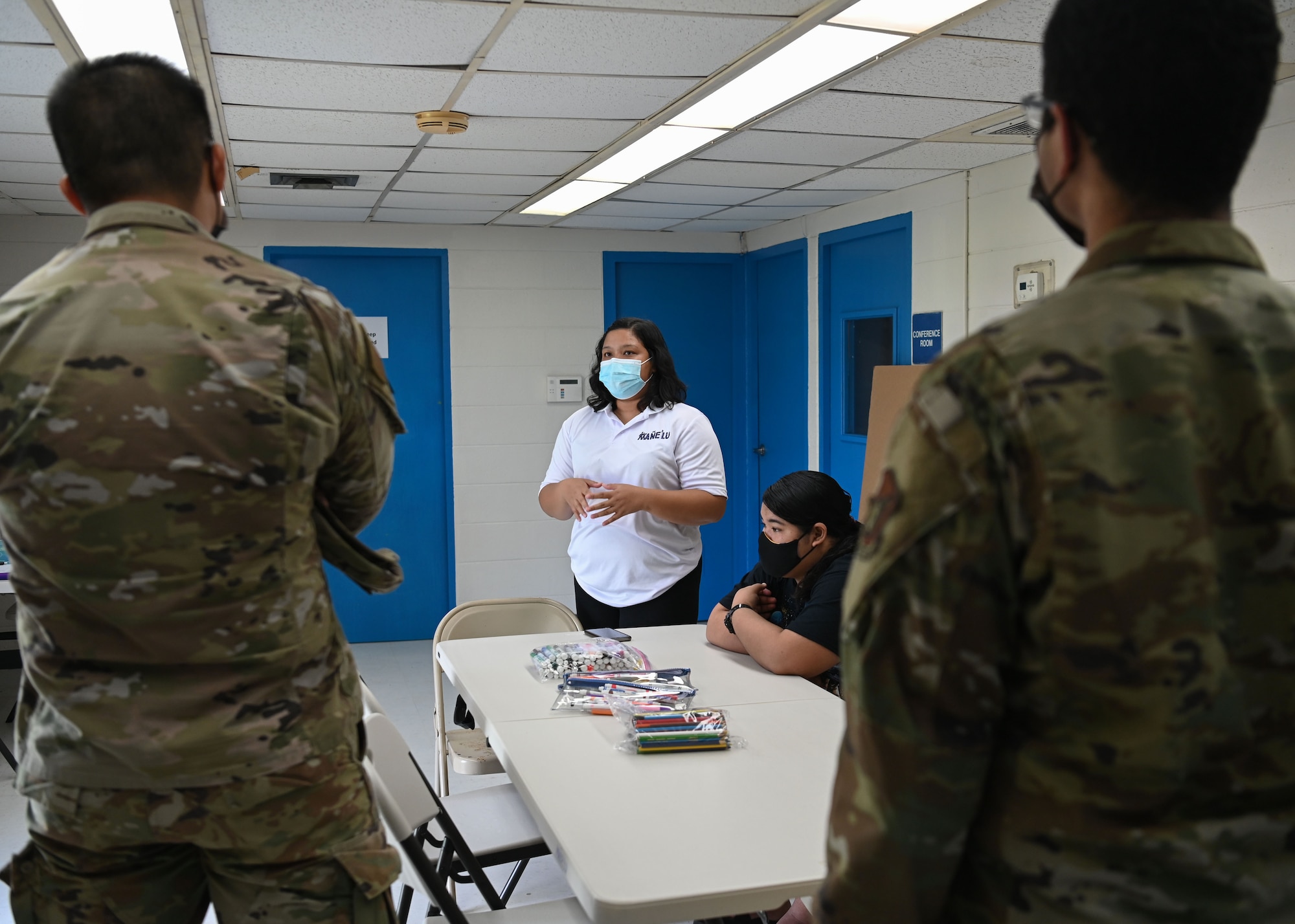 Jemimah Nelson, a project assistant and facilitator with Mañe'lu, speaks with U.S. Air Force Airman 1st Class Lijie Lu, budget analysis with 36th Comptroller Squadron, and U.S. Air Force A1C Joshua Thompson, a budget analysis with 36 CPTS, during a volunteer event at Toto Garden, Mongmong-Toto-Maite, Nov. 18th, 2021. The two Airmen from 36 CPTS volunteered through Andersen Air Force Base’s Sister Village Sister Squadron program and joined the children with Mañe'lu to decorate boxes that will be used during Operation Christmas Drop with donated supplies. (U.S. Air Force photo by Senior Airman Aubree Owens)