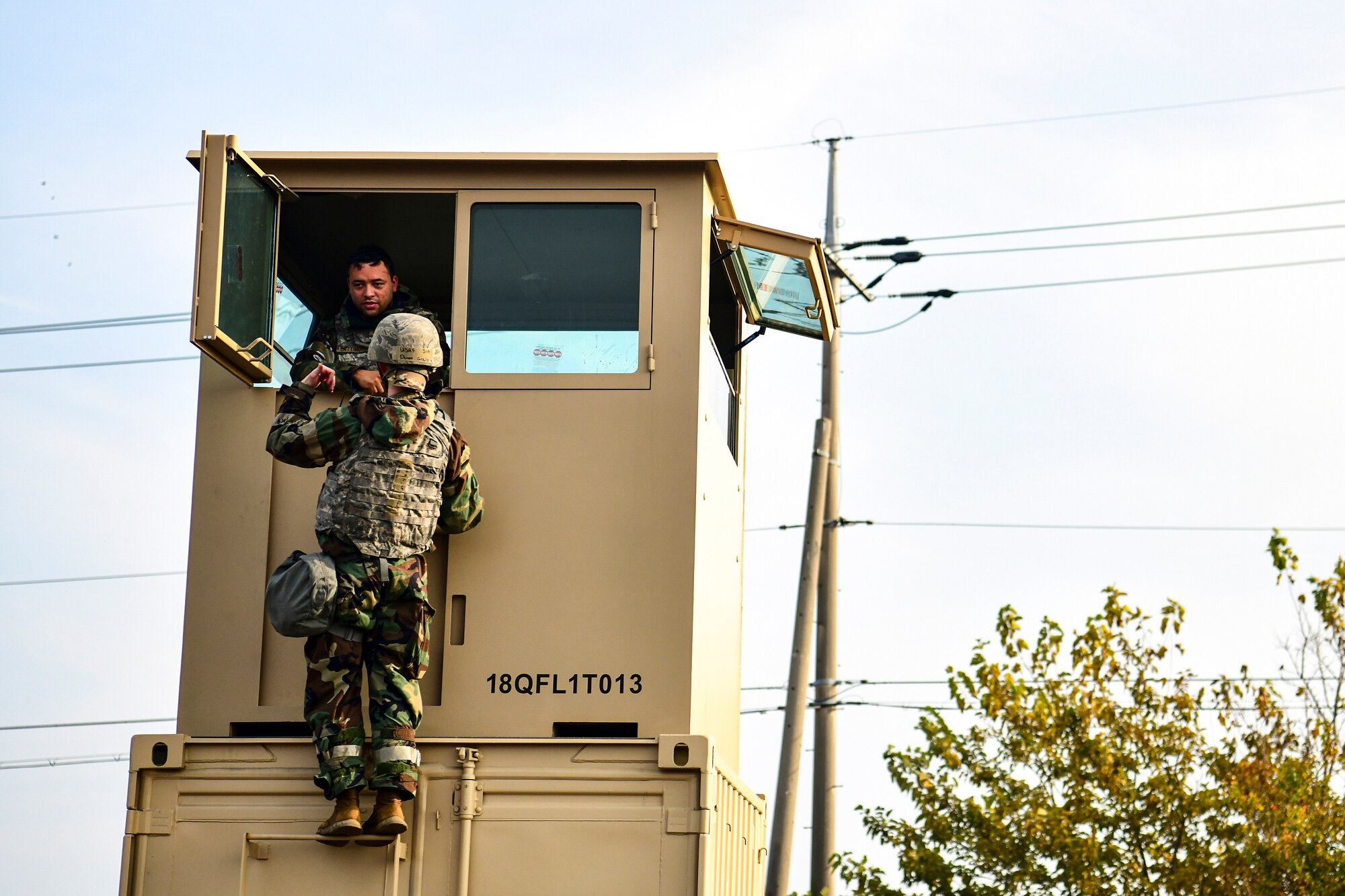 An Airman offers food to another Airman.